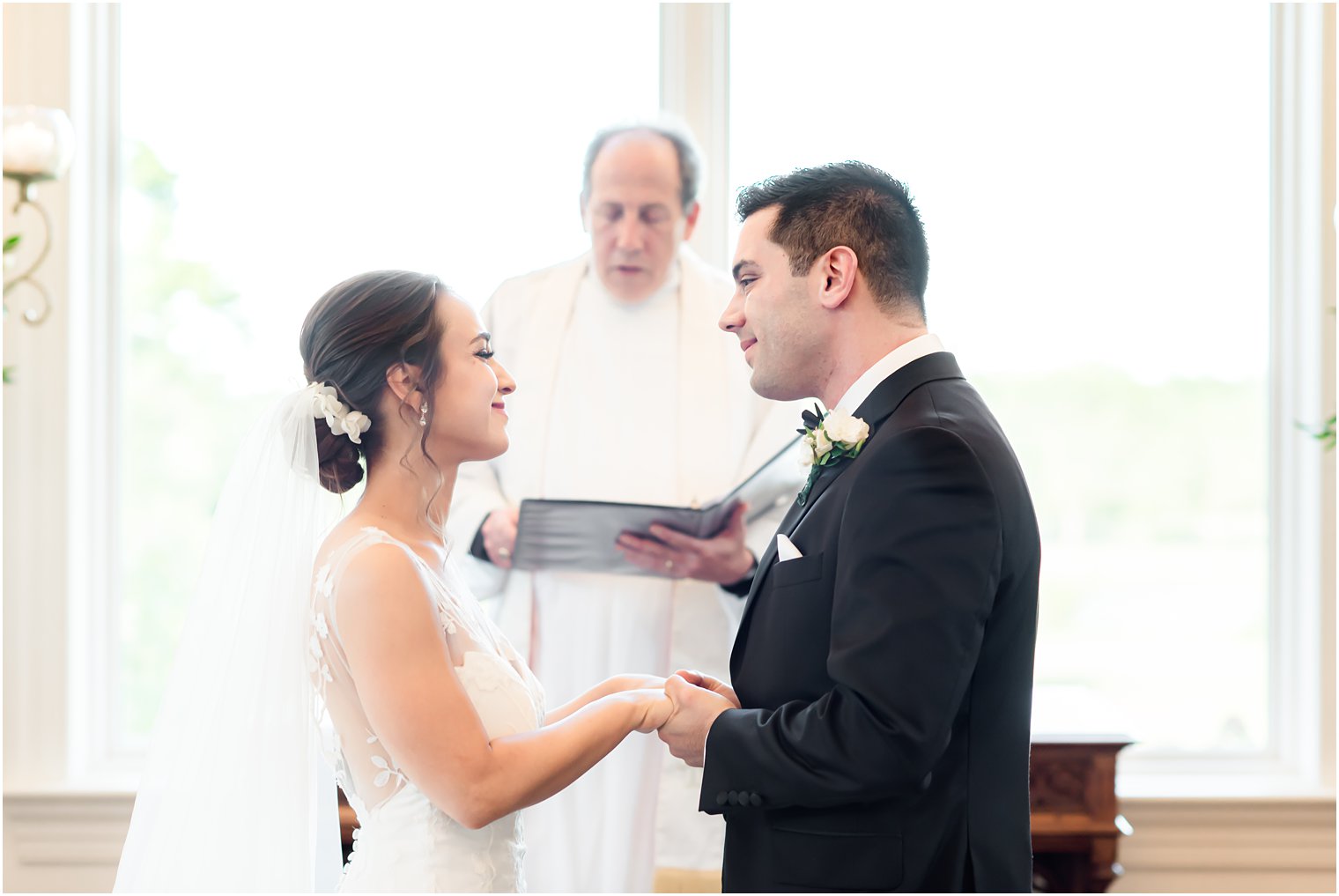 bride and groom smile at each other during Park Savoy Estate wedding ceremony 