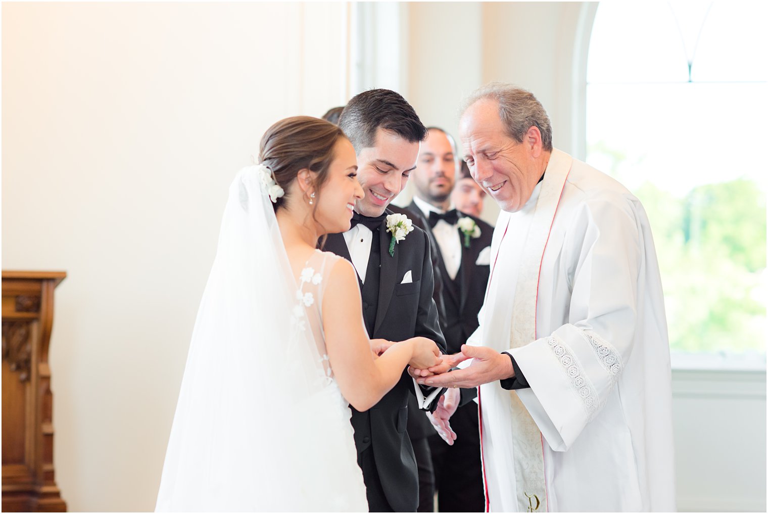 bride and groom exchange rings during NJ wedding ceremony 