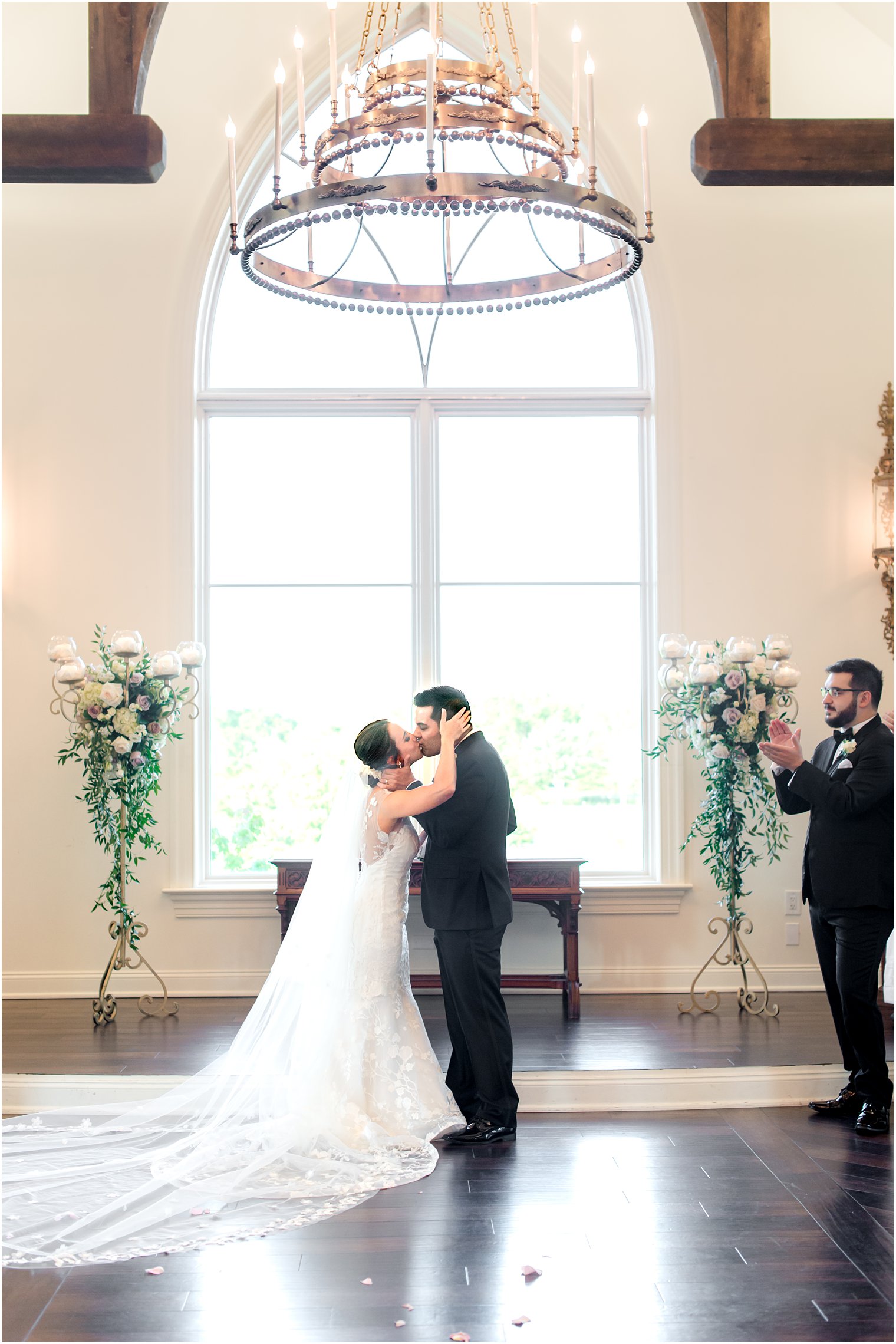 bride and groom kiss at end of aisle at Park Savoy Estate