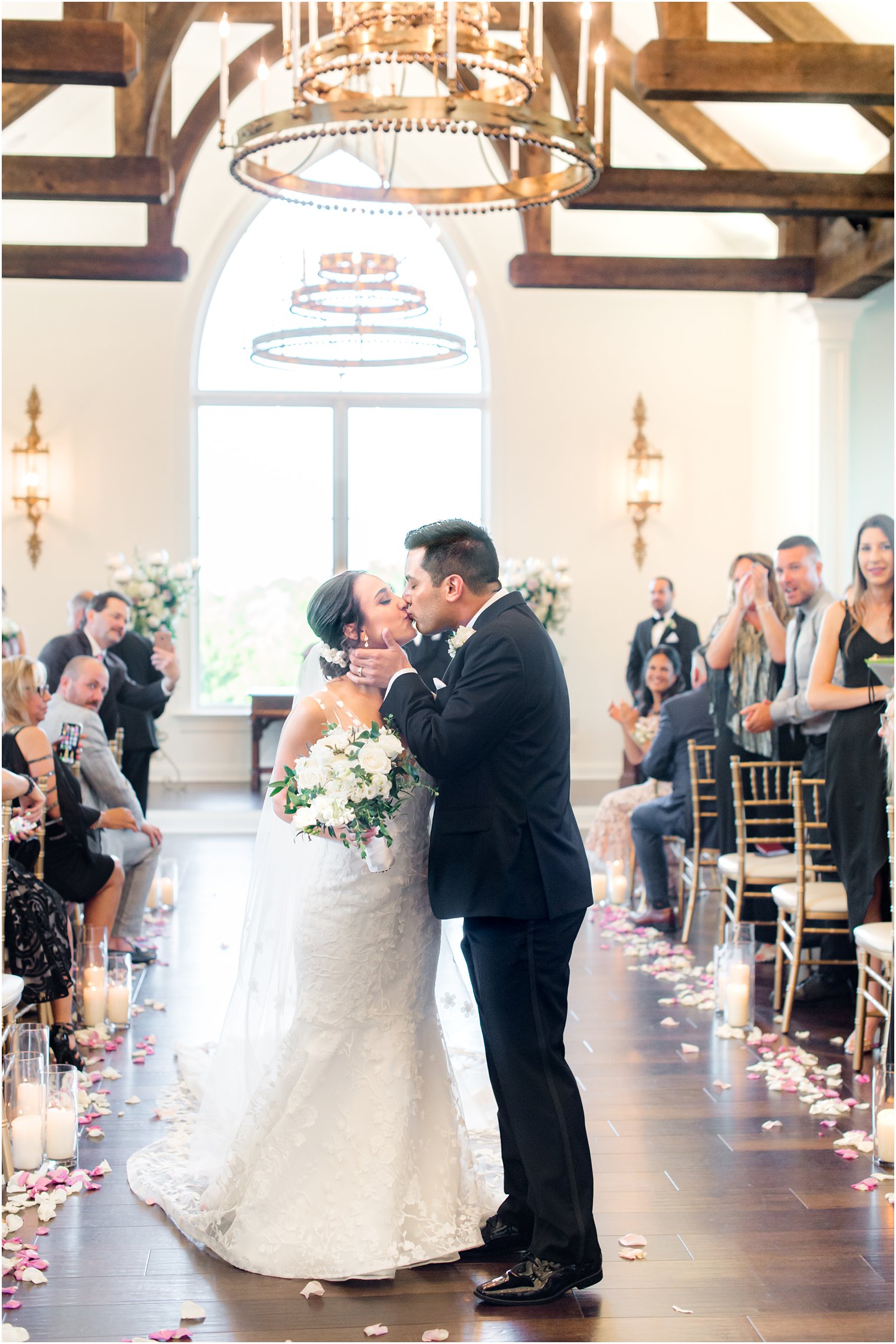 newlyweds kiss at end of aisle in chapel at Park Savoy Estate