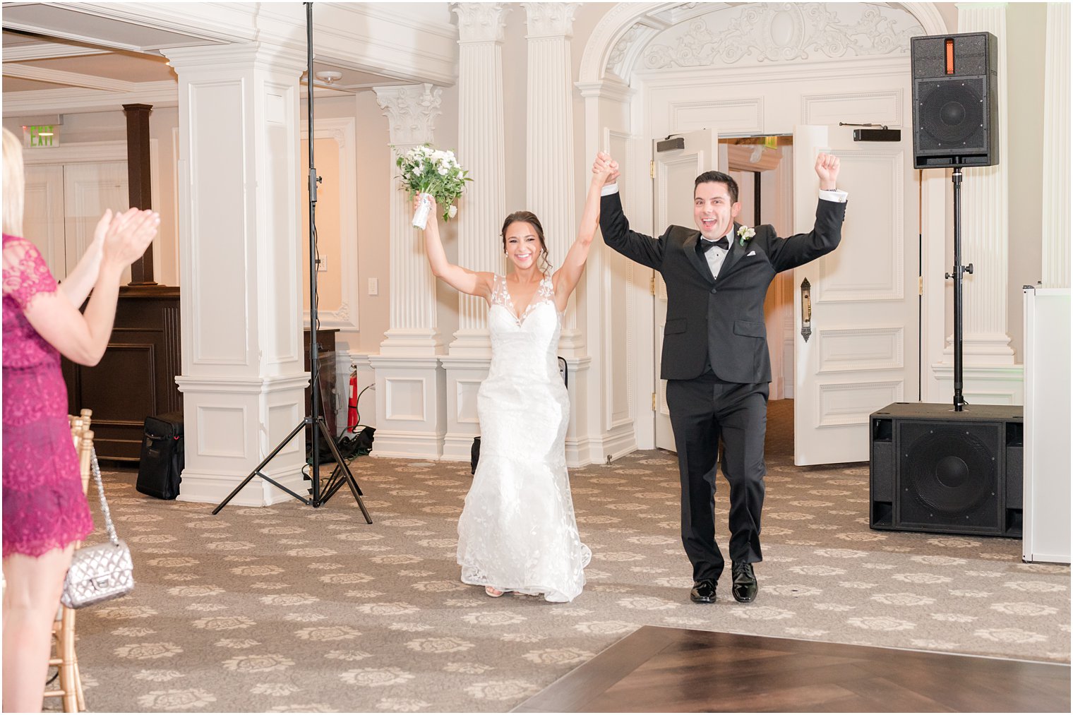 bride and groom cheer walking into NJ wedding reception 