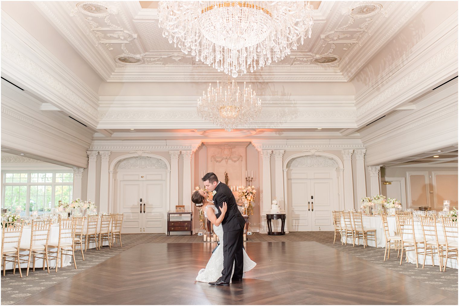 groom dips bride in ballroom at Park Savoy Estate