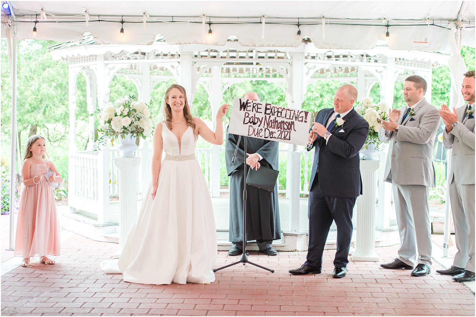 baby announcement at the end of wedding ceremony at Forsgate Country Club