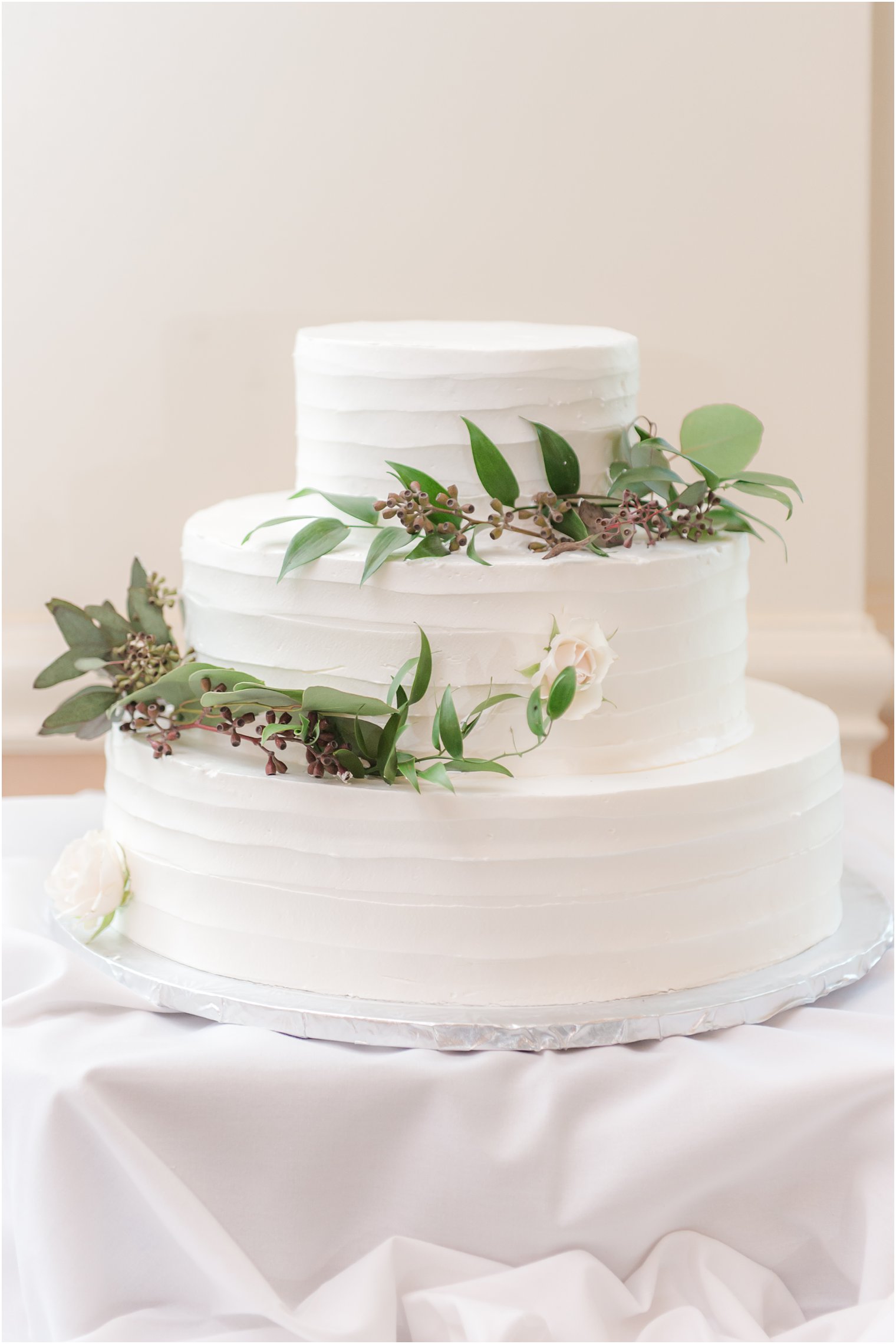 tiered wedding cake with greenery accents for NJ wedding day