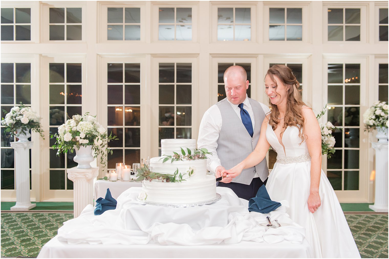 bride and groom cut wedding cake during NJ wedding reception 