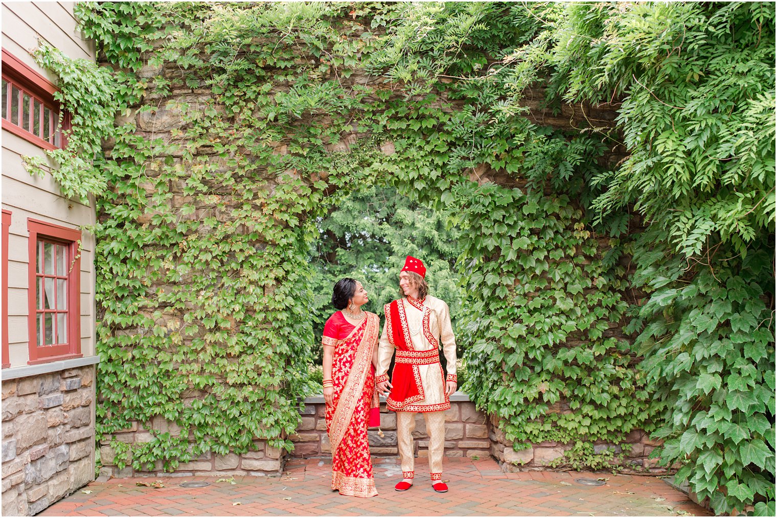 bride and groom pose by ivy covered wall at the Ashford Estate 