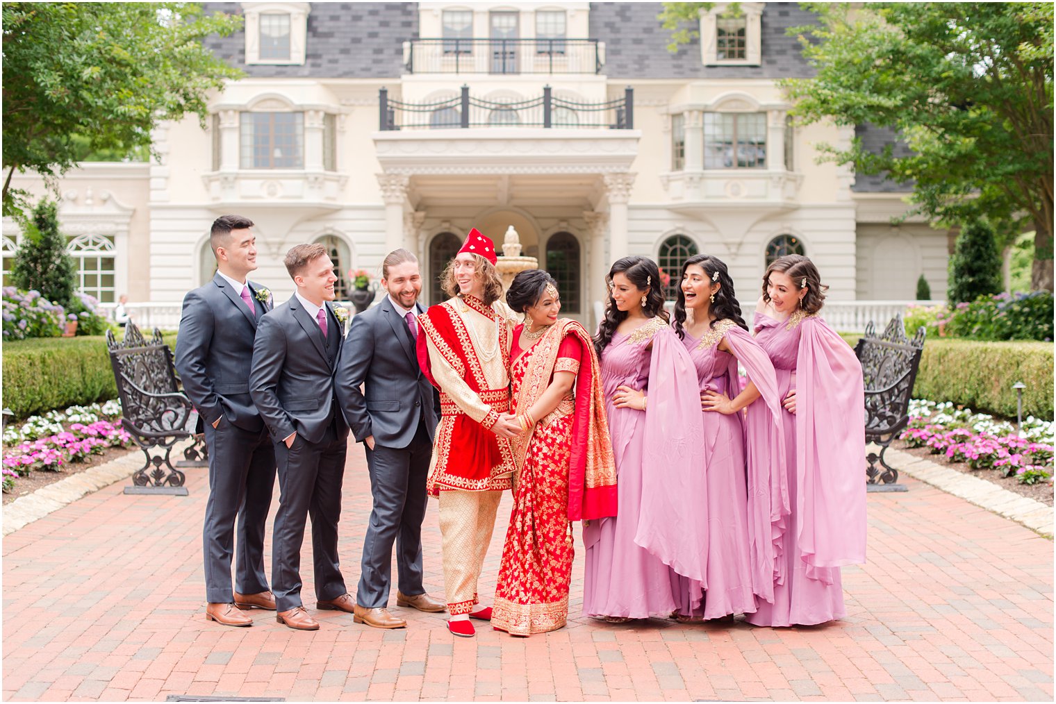 bride and groom pose with wedding party outside Ashford Estate 