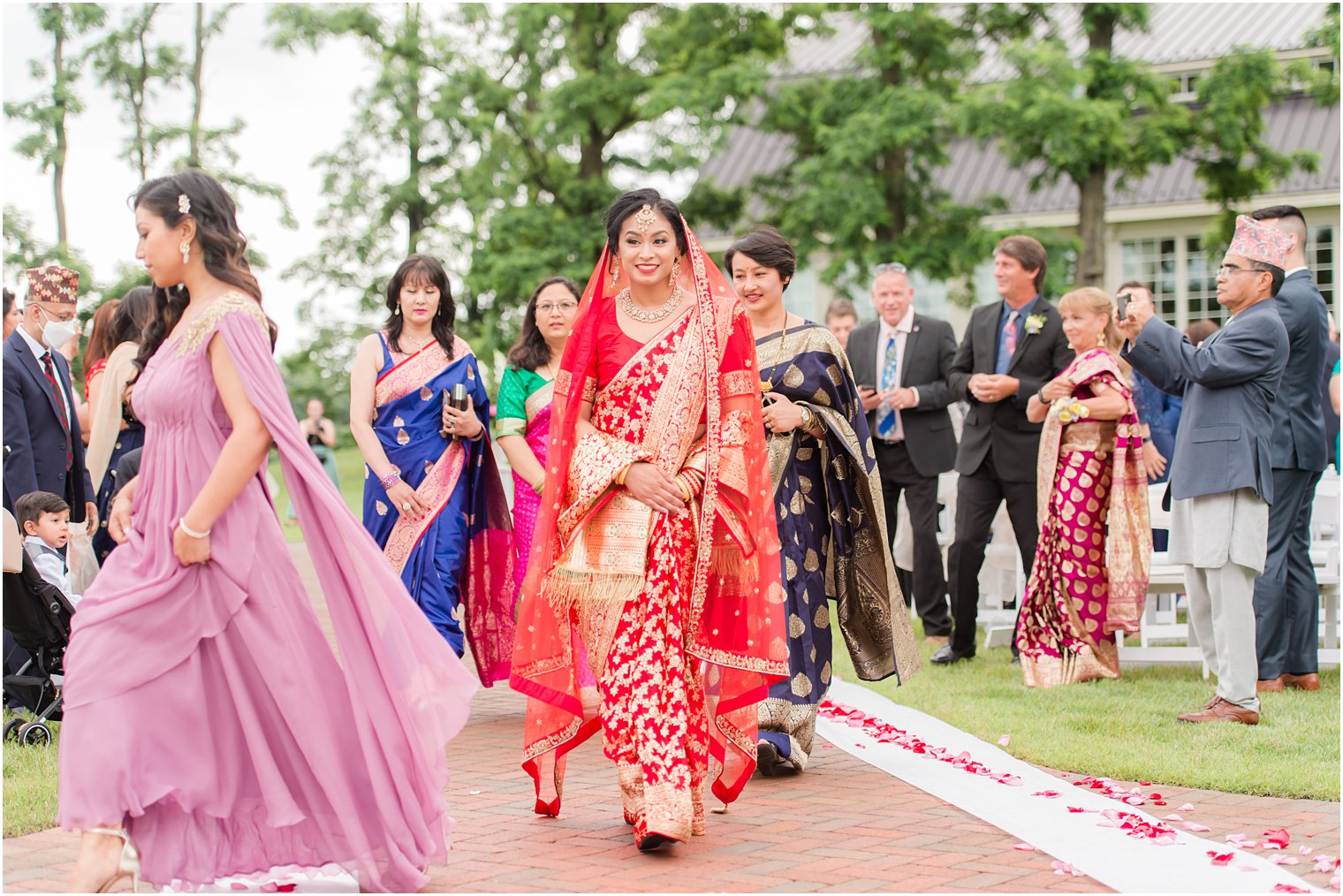 bridesmaids lead bride down aisle during Indian wedding at the Ashford Estate