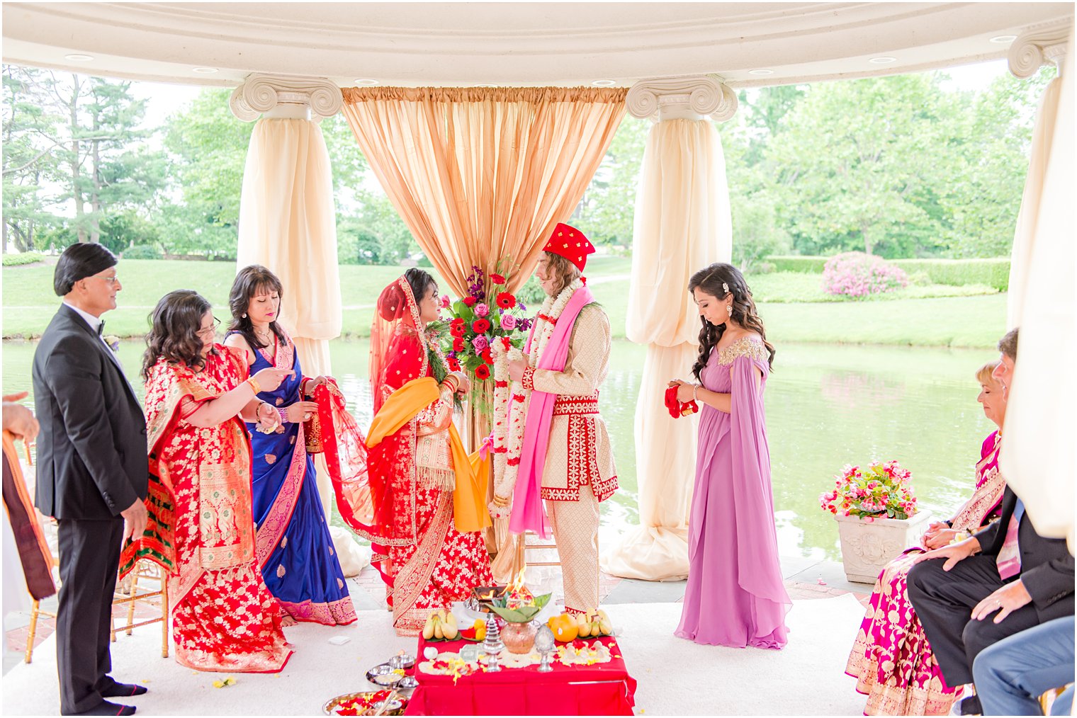 newlyweds stand together along waterfront during traditional Indian wedding at the Ashford Estate