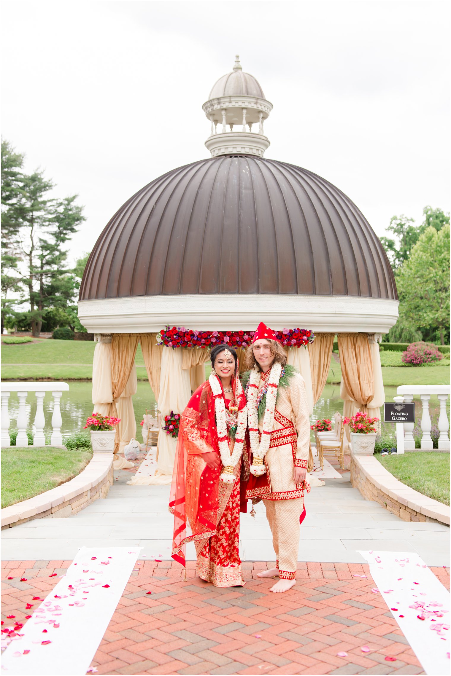 newlyweds pose by floral decor at Ashford Estate 