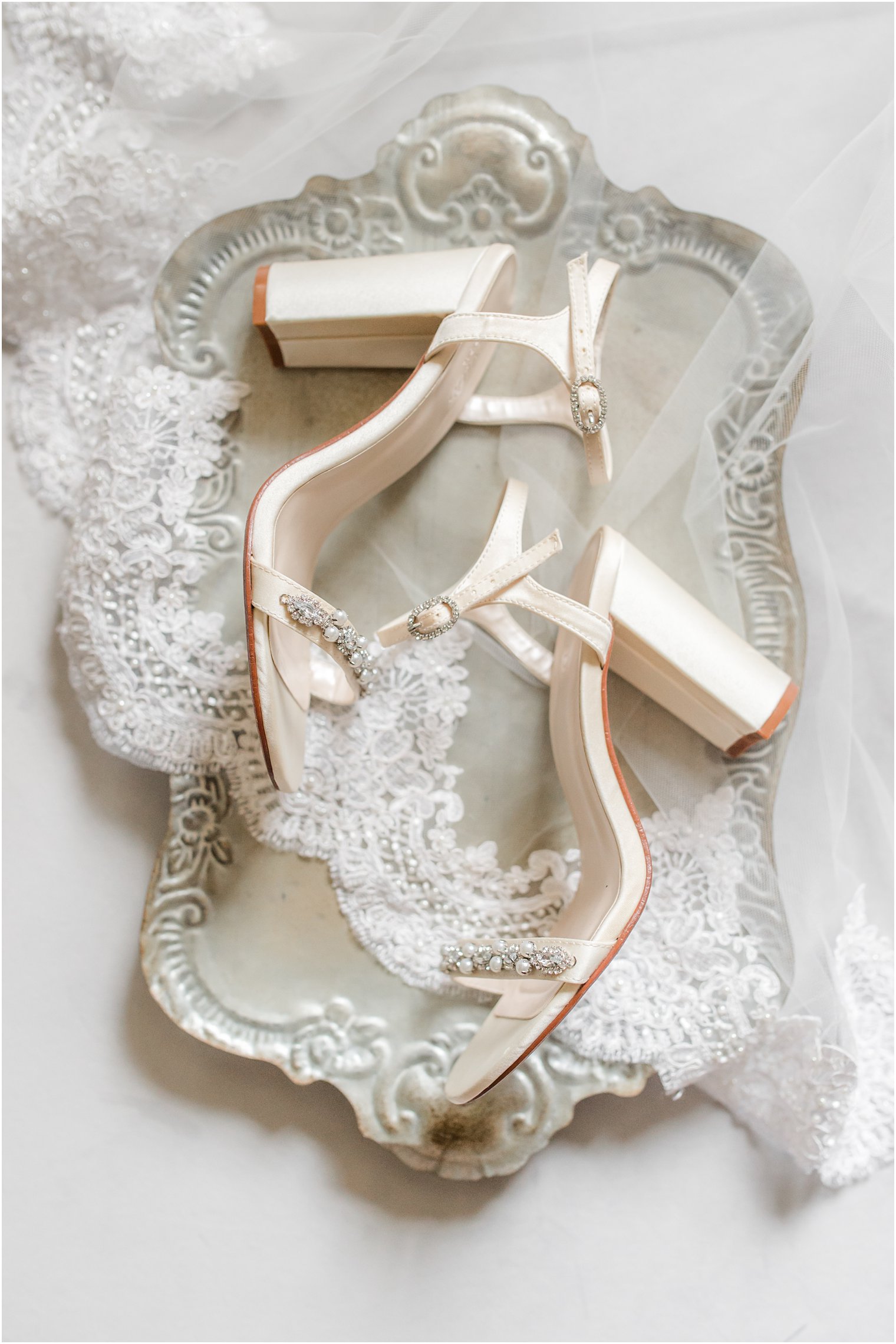 bride's ivory shoes lay on metal tray before NJ wedding 