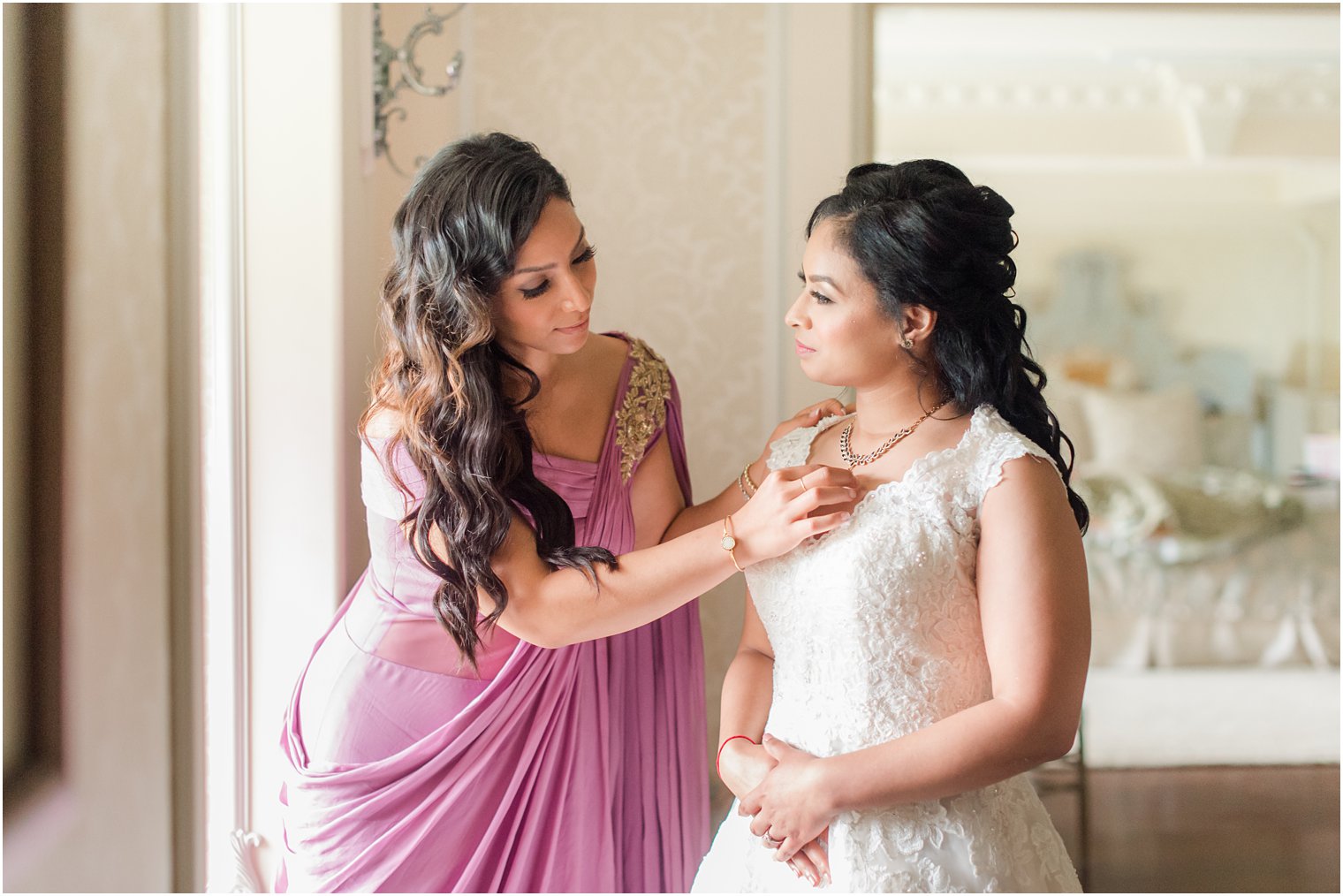 bridesmaid helps bride with necklace at Ashford Estate