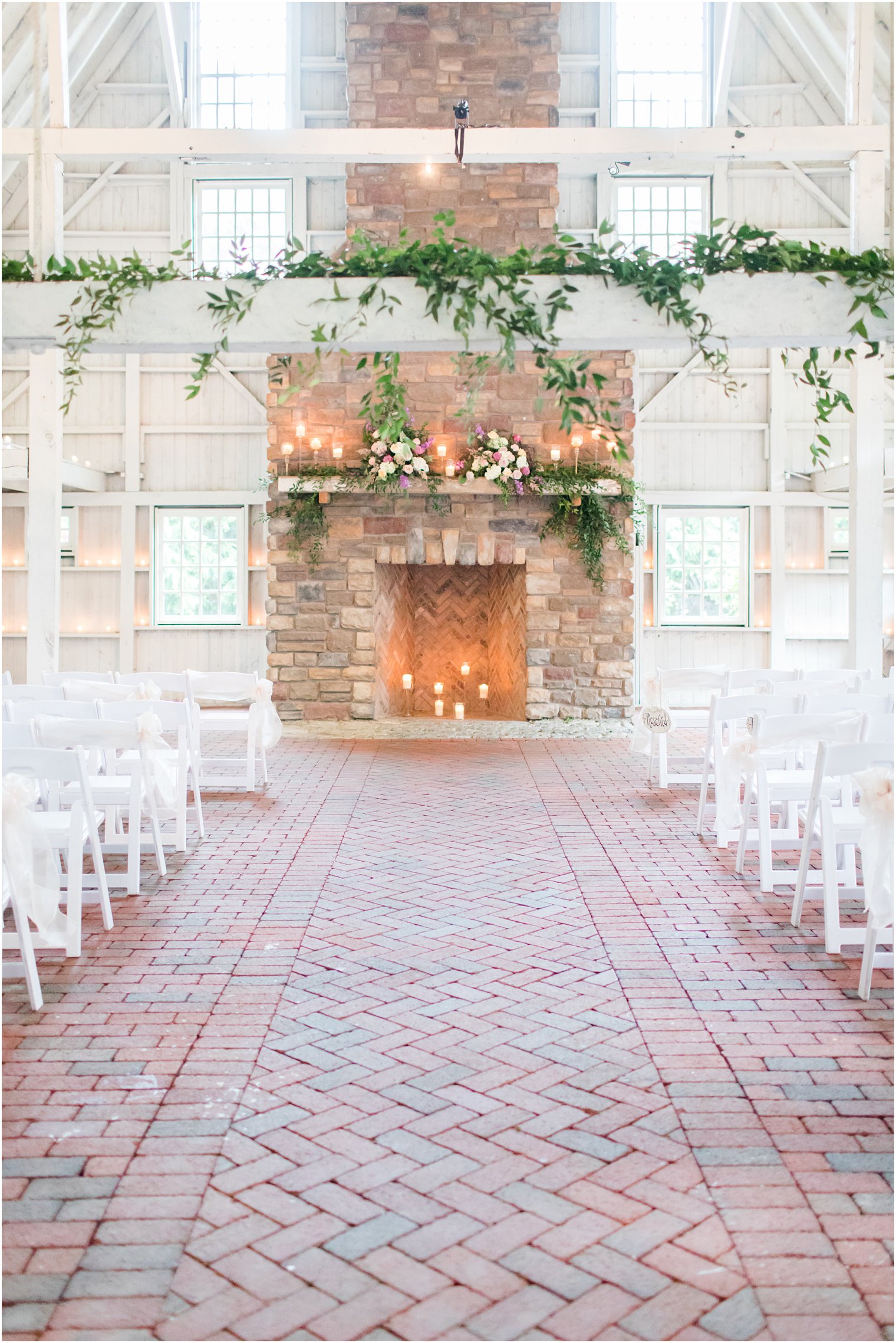ceremony setup with stone fireplace and greenery at Ashford Estate