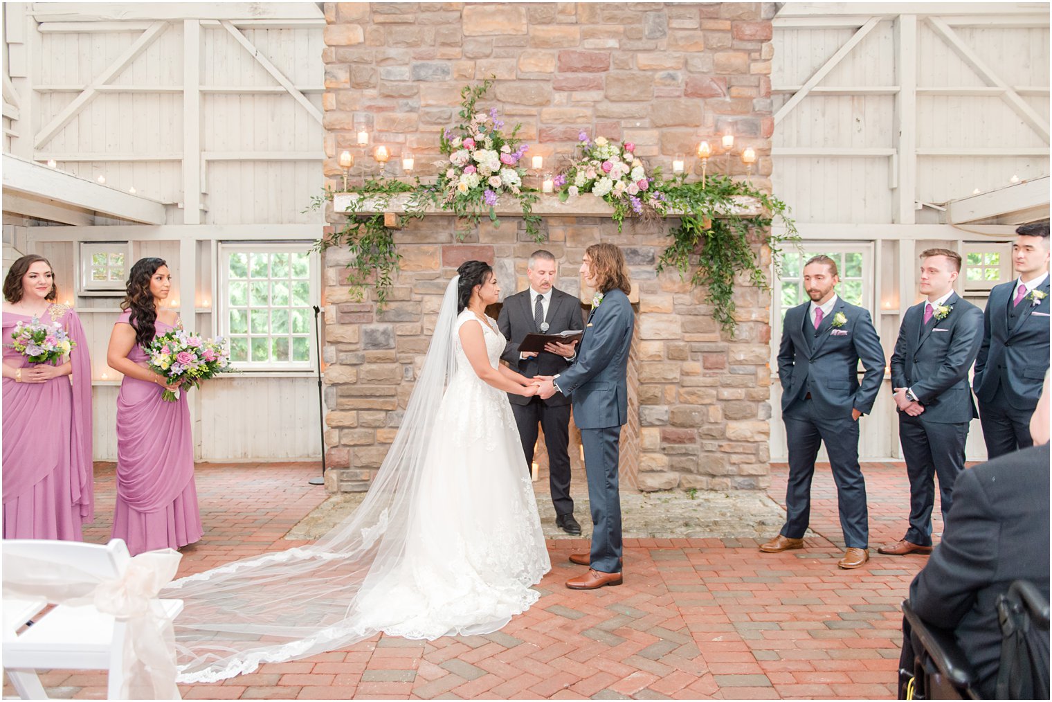 bride and groom hold hands during ceremony at Ashford Estate