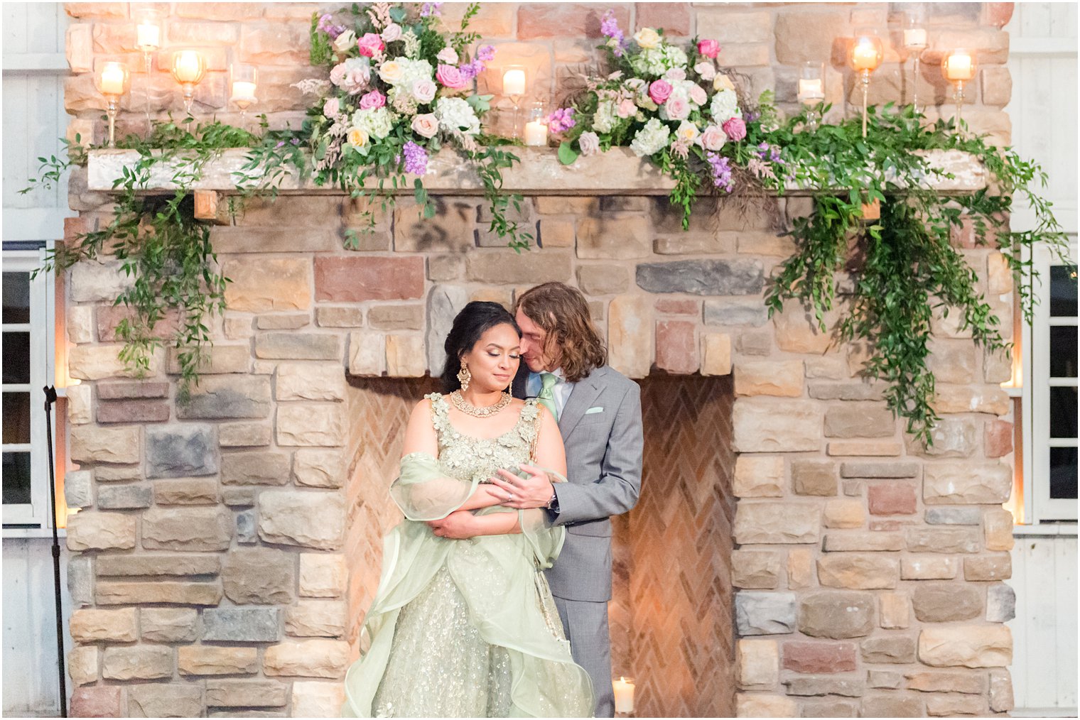 groom hugs bride in green wedding gown 