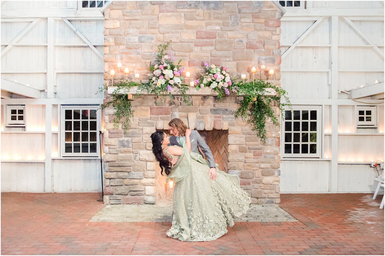 groom dips bride in mint green wedding attire 