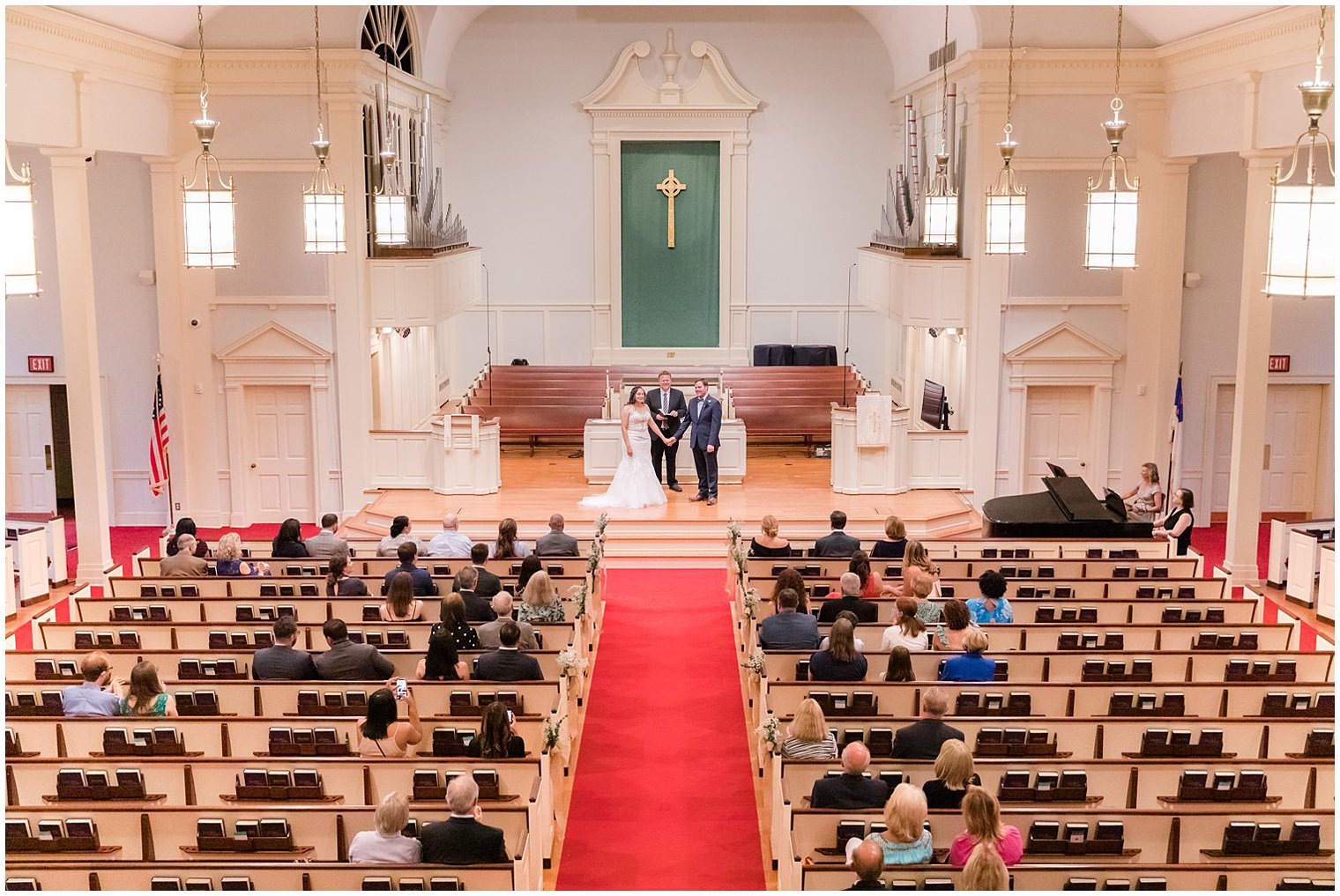 engaged couple looks at guests during traditional church wedding in Red Bank New Jersey 
