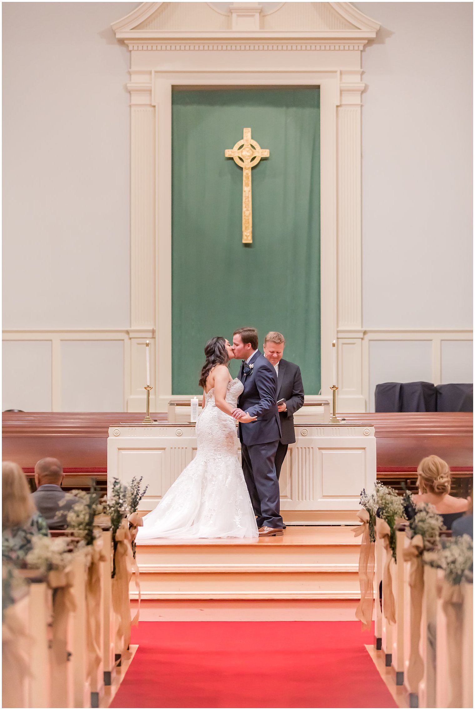 newlyweds kiss at end of traditional church wedding in Red Bank New Jersey 