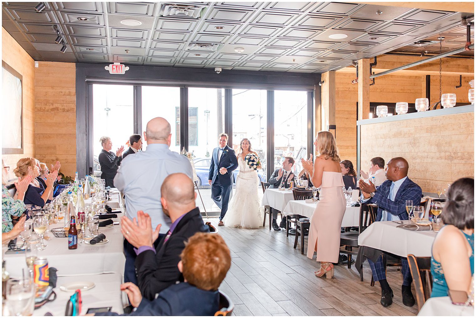 couple enters Red Bank NJ wedding reception at Neapoli 