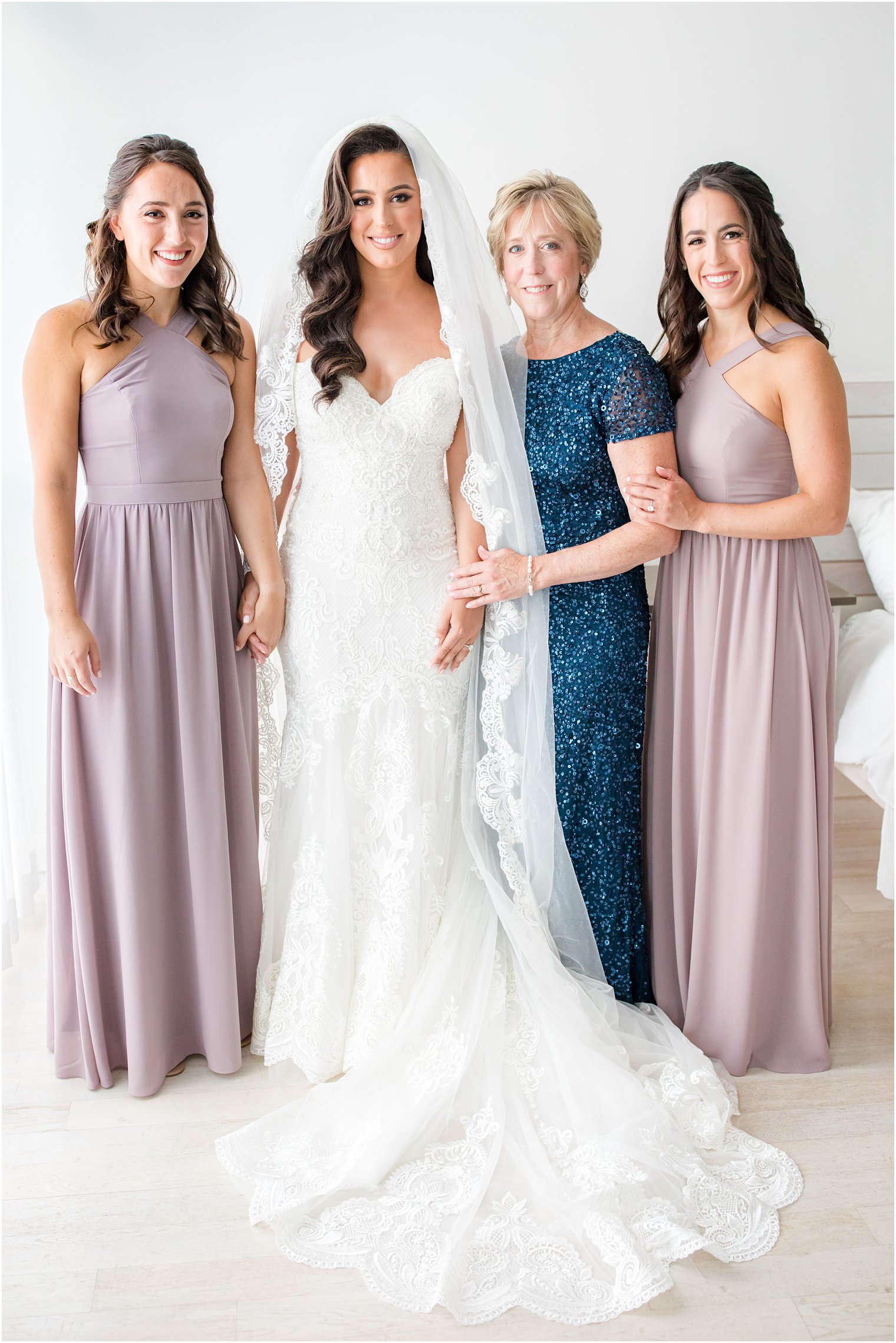 bride poses with bridesmaids and mother after preparing for Navesink Country Club wedding