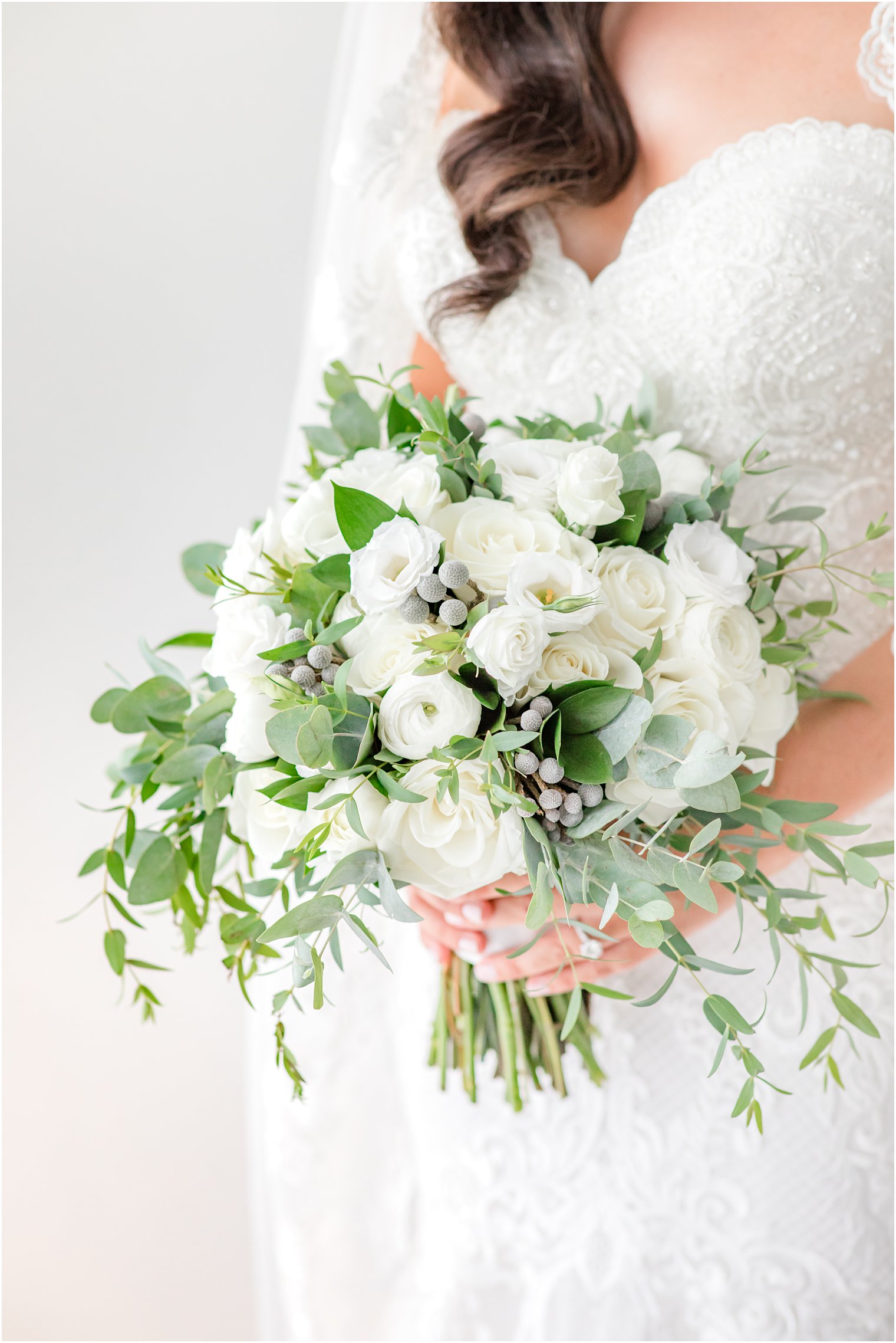 bride holds bouquet of white flowers and greenery for Navesink Country Club wedding