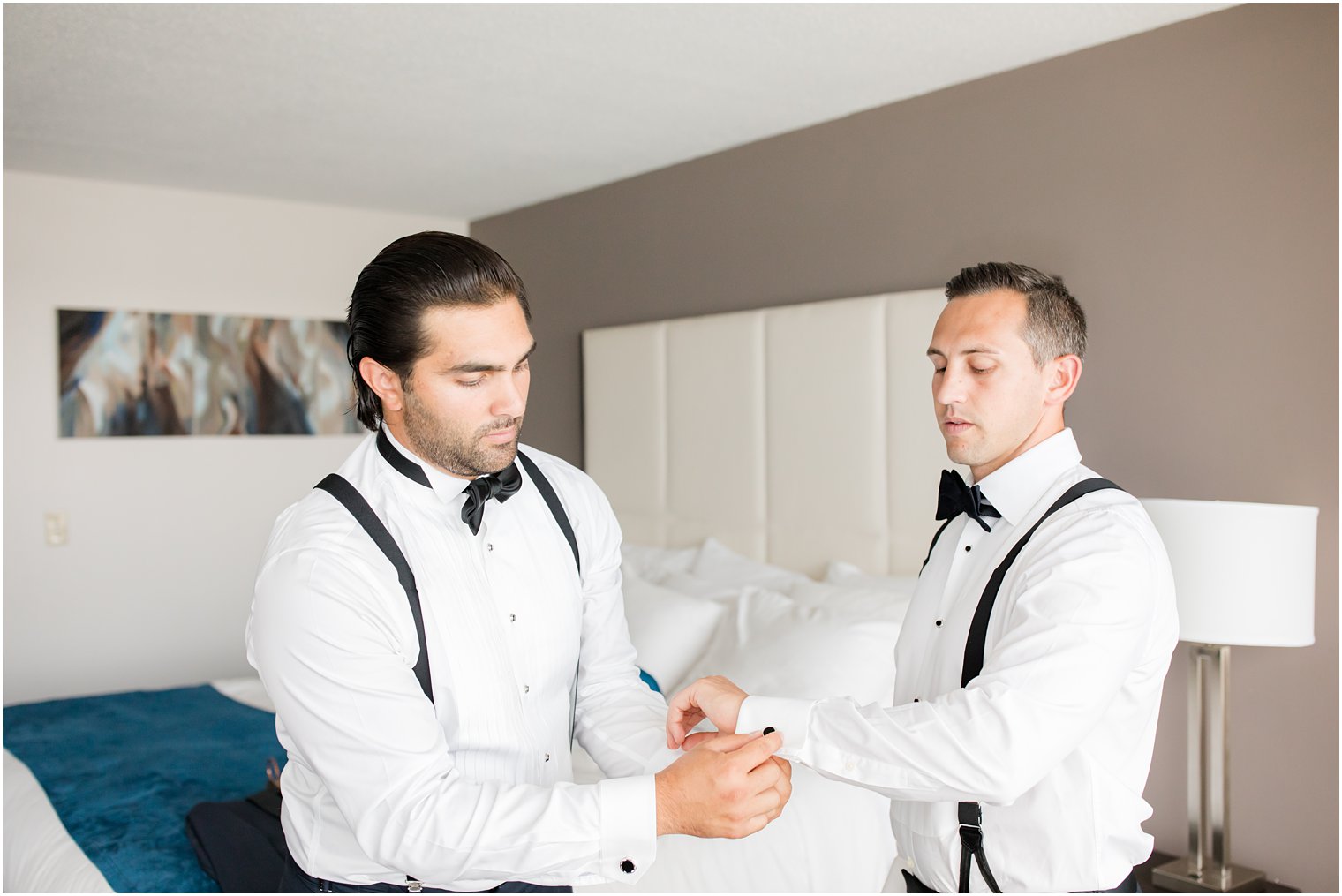 groomsman helps groom with cufflinks for NJ wedding
