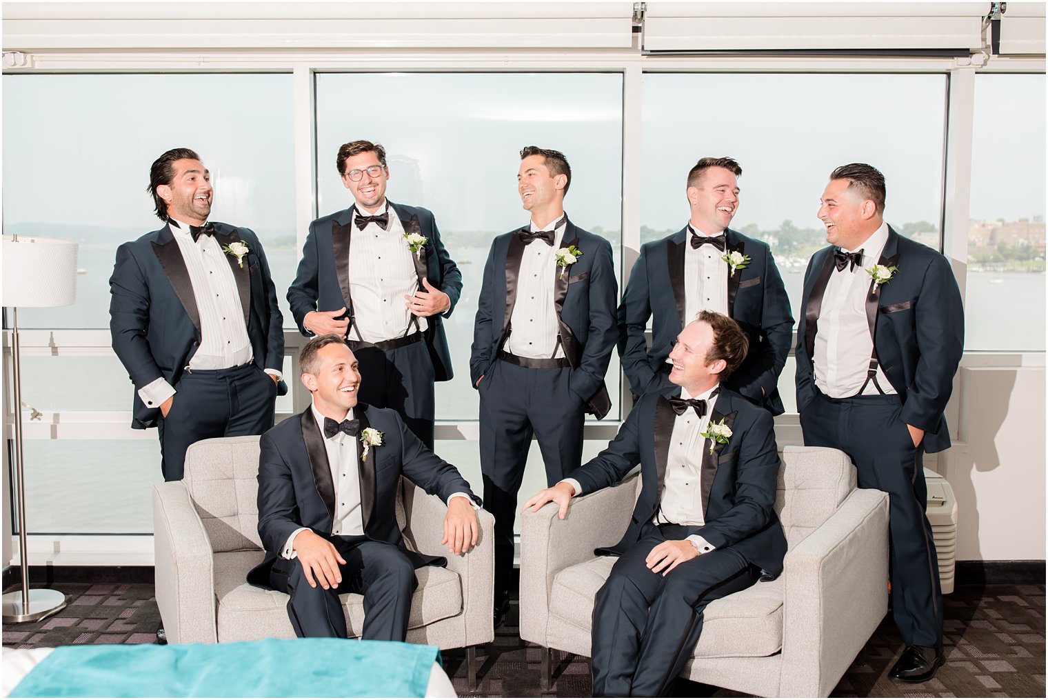 groom and groomsmen laugh at Navesink Country Club