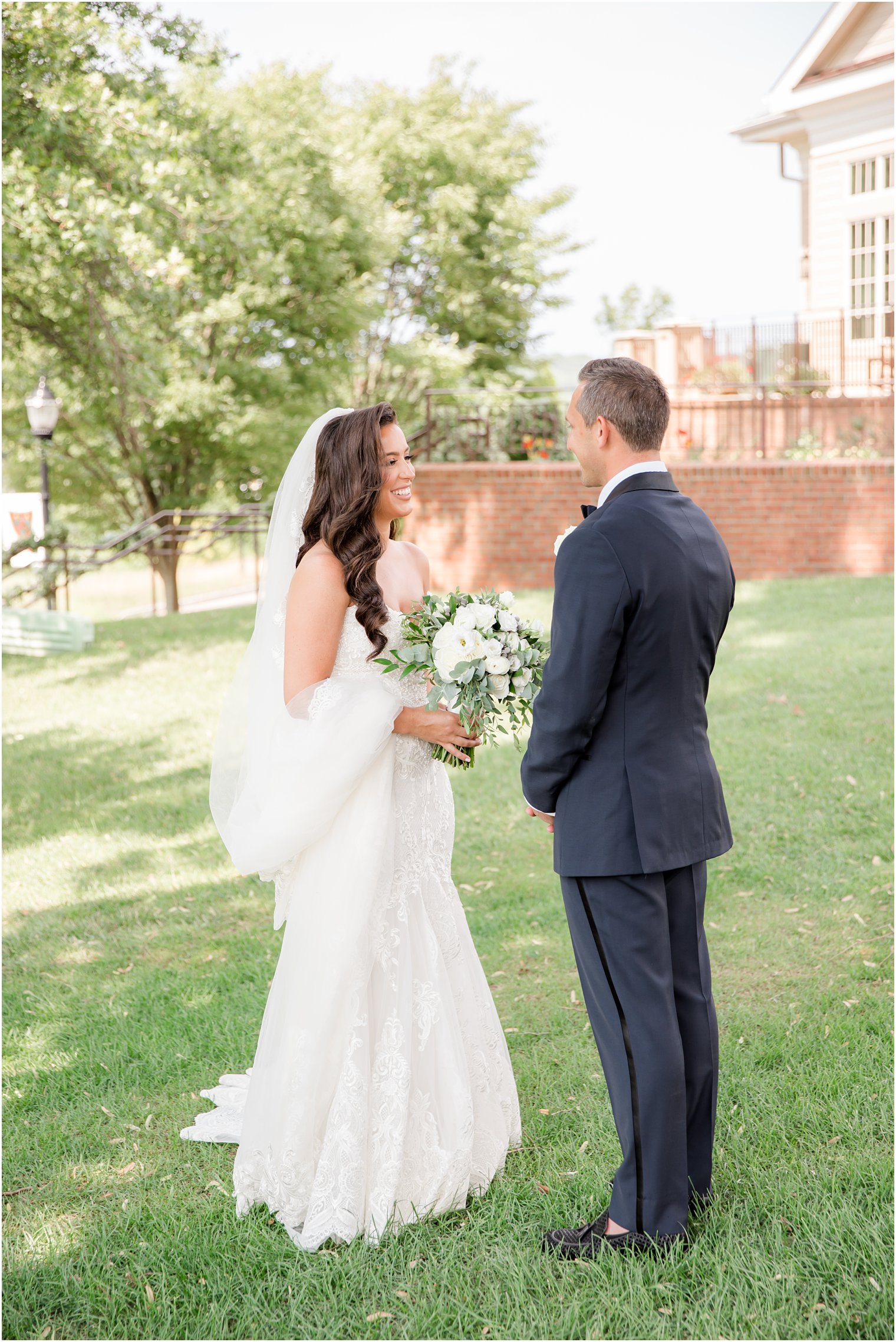 bride and groom laugh on lawn at Navesink Country Club during first look