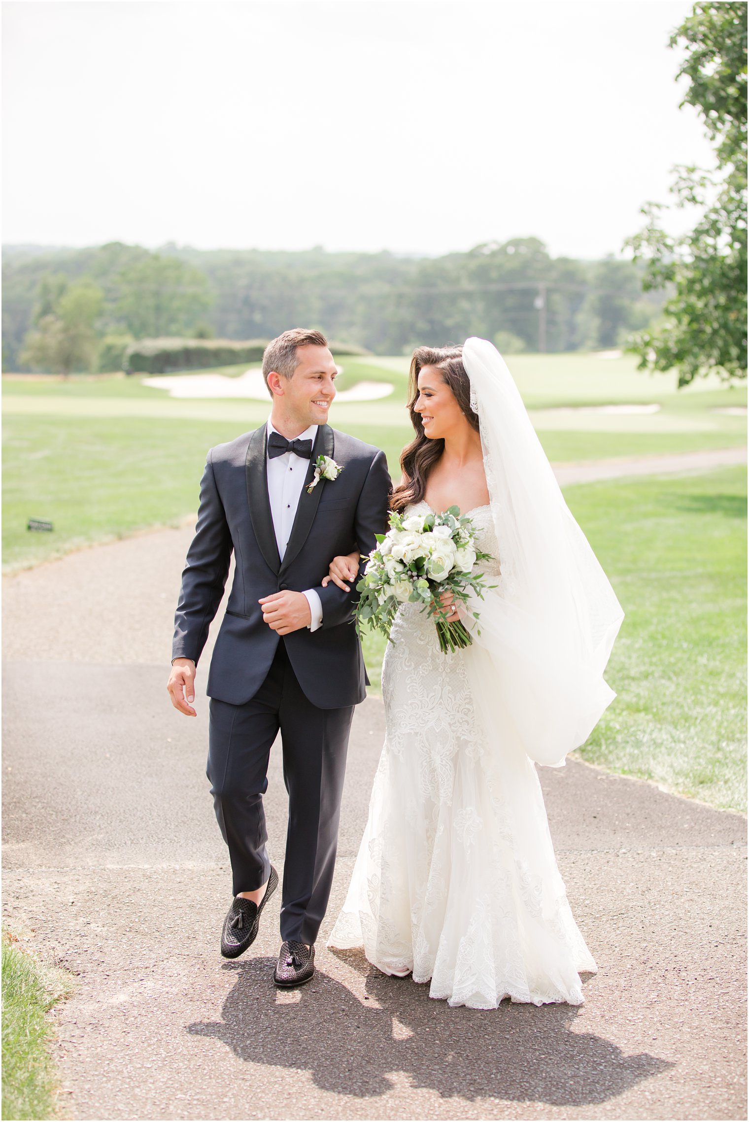 bride and groom walk through golf course at Navesink Country Club