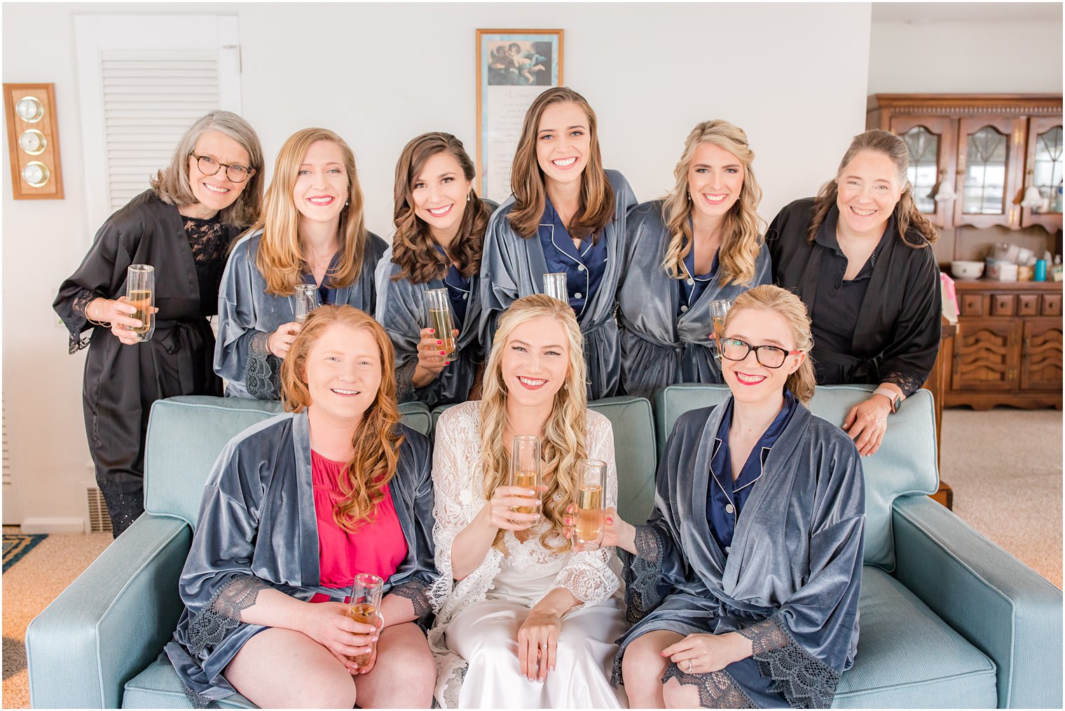 bridesmaids and moms pose with bride before NJ wedding