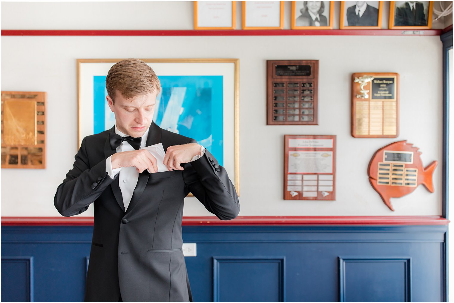 groom adjusts pocket square before Ocean City Yacht Club wedding