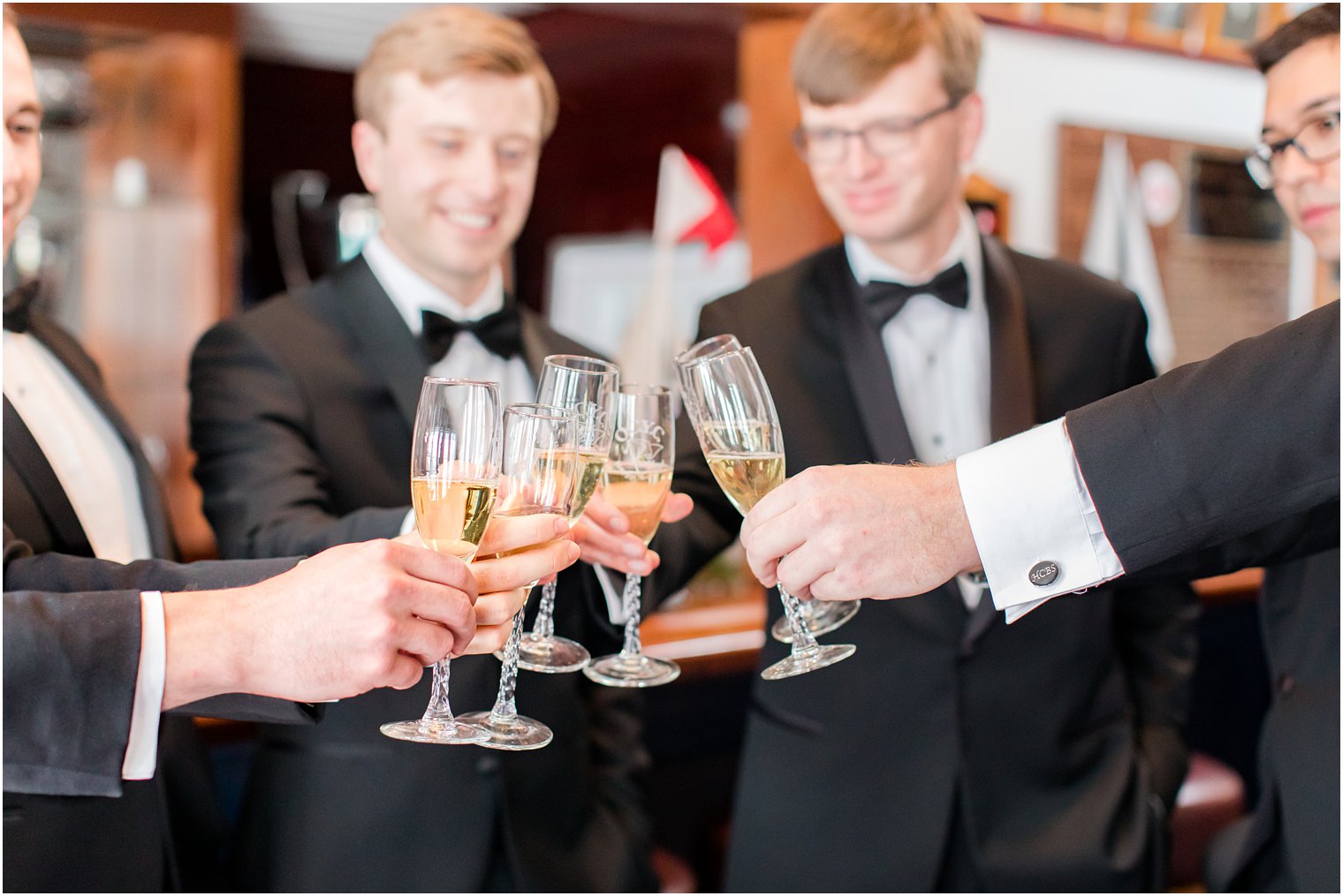 groom and groomsmen toast with champagne before NJ wedding