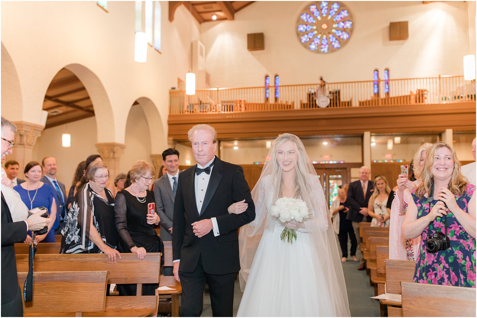 bride walks down aisle at traditional church wedding in Ocean City NJ