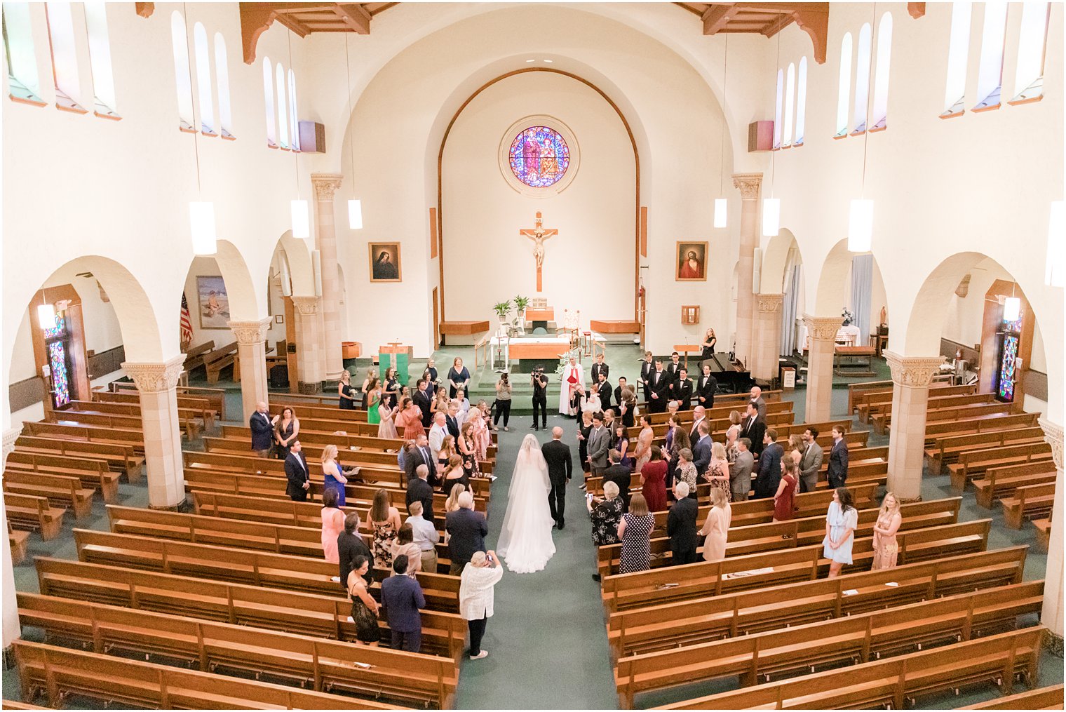 bride walks down aisle with father during traditional church wedding in Ocean City NJ