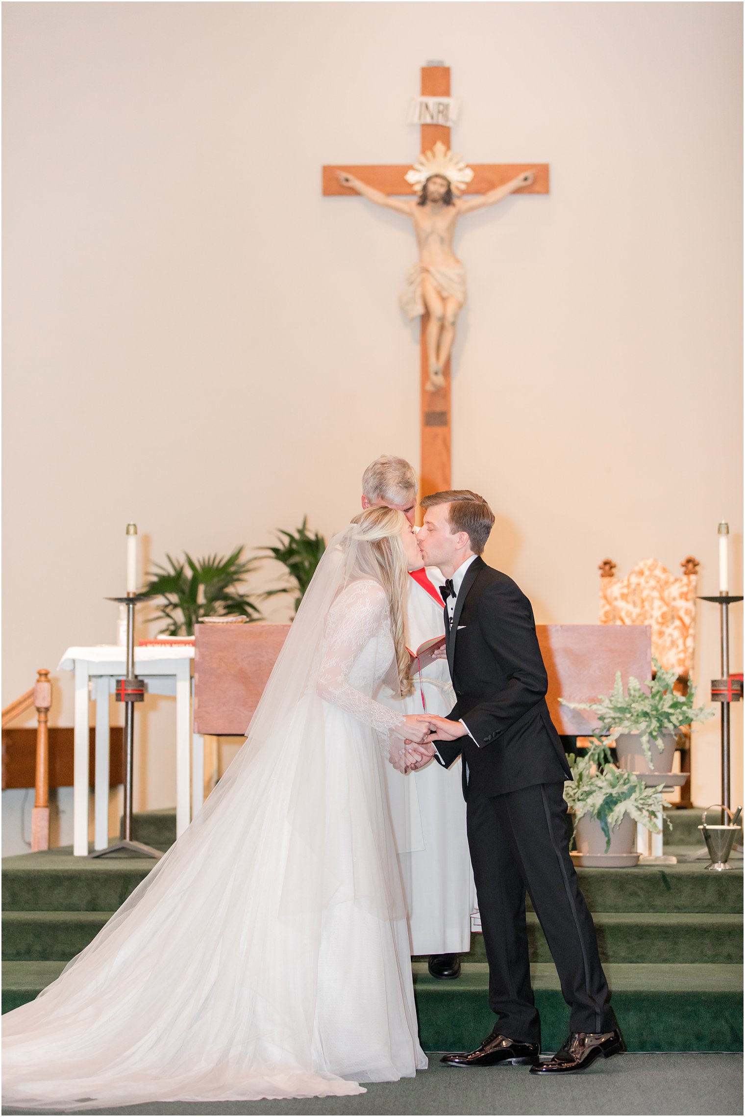 bride and groom kiss during traditional church wedding in Ocean City NJ