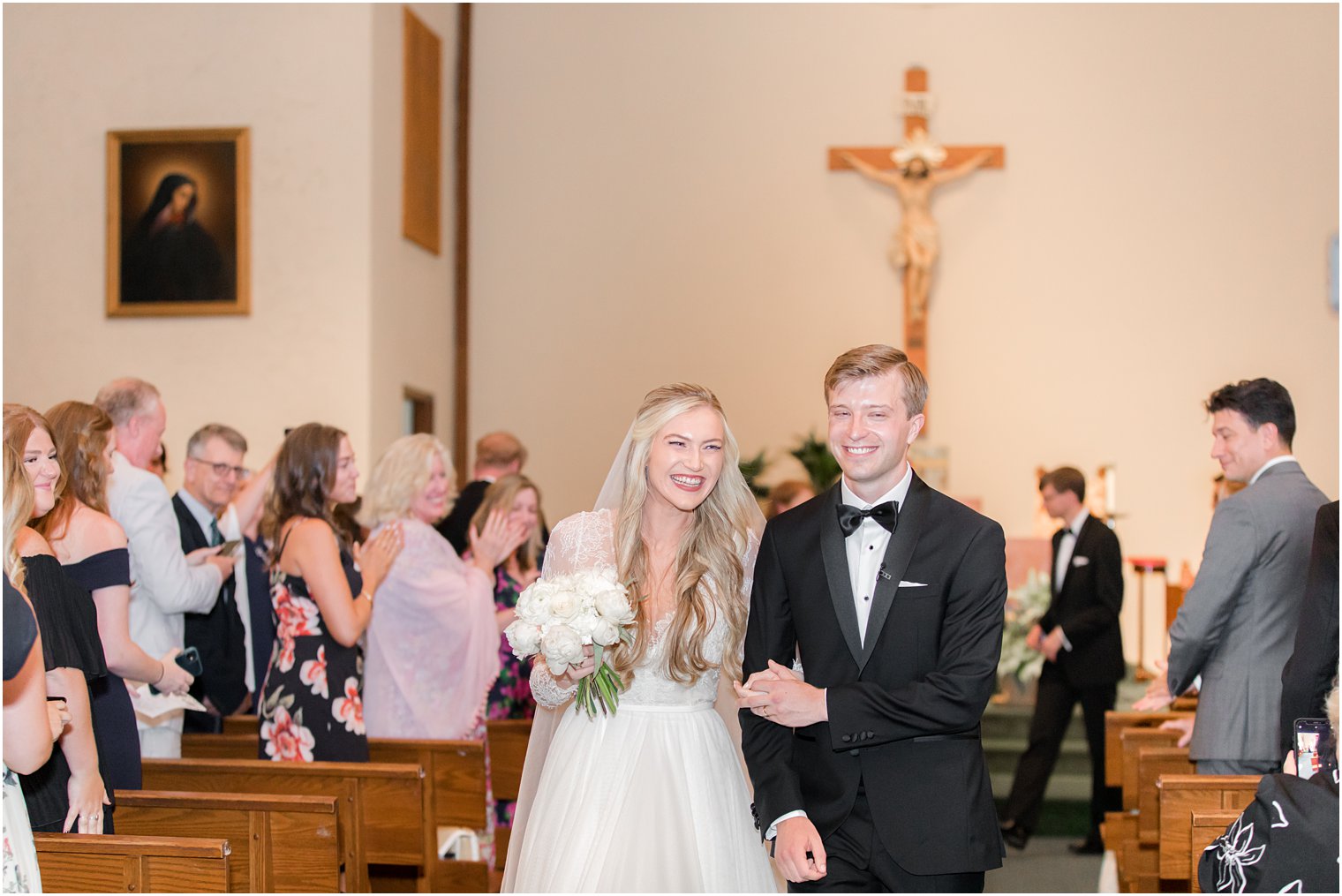 bride and groom leave traditional church wedding in Ocean City NJ