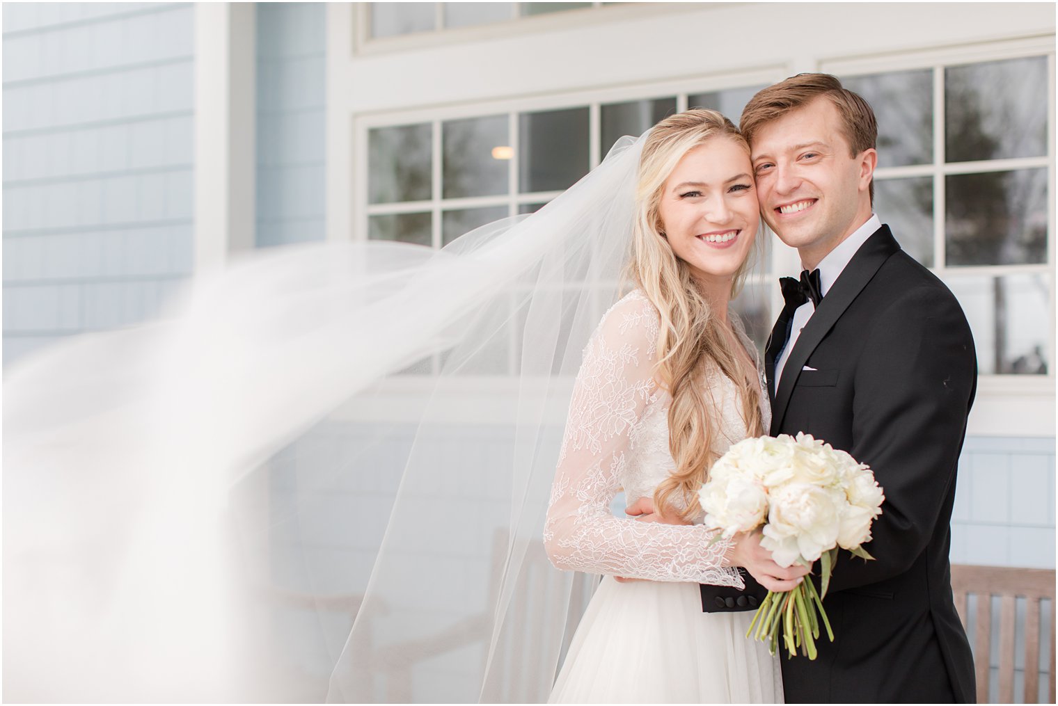 bride and groom pose with heads together on rainy wedding day in NJ