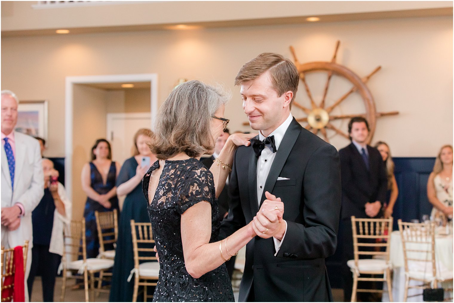 groom dances with mother during wedding reception 