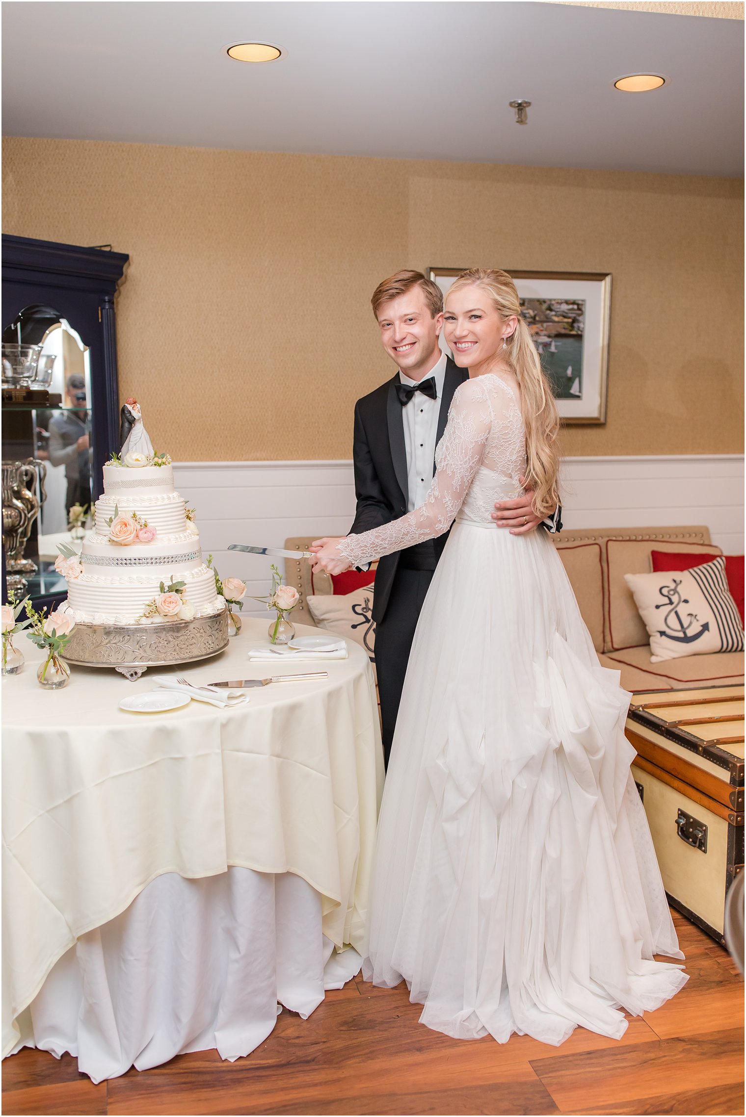 bride and groom cut tiered wedding cake at Ocean City Yacht Club