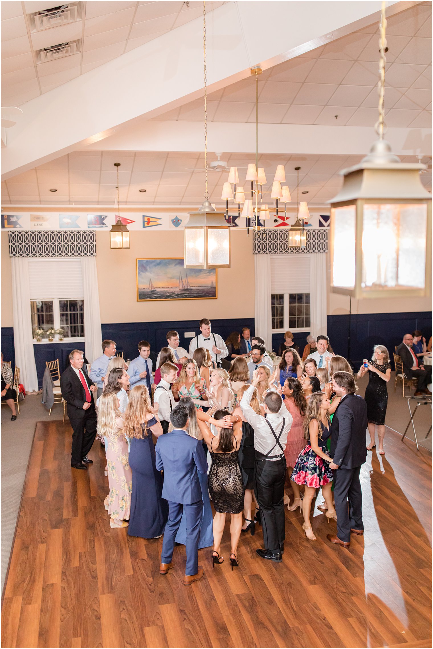 bride and groom dance with guests on dance floor at Ocean City Yacht Club