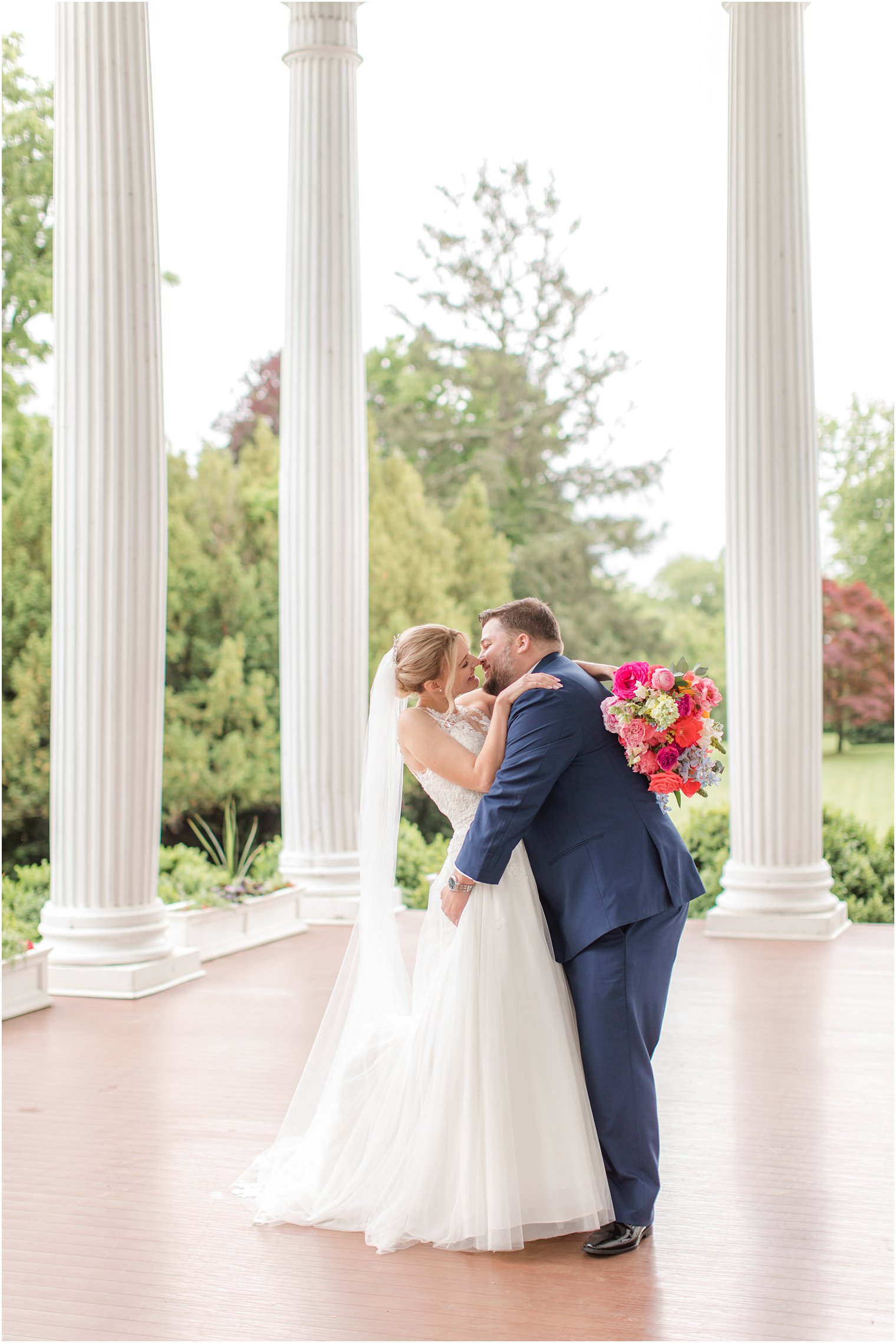bride and groom kiss on Rosemont Manor patio