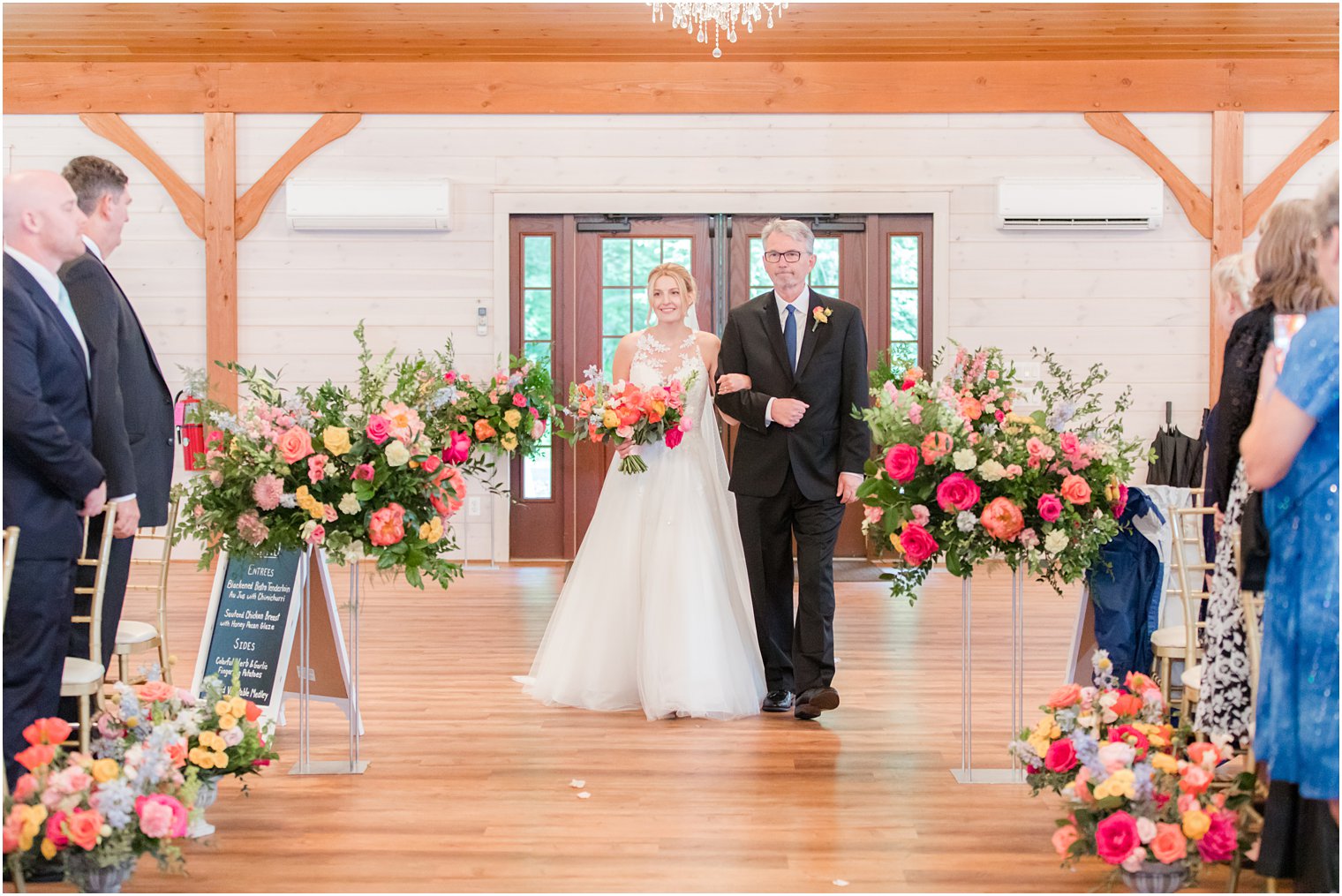 bride walks down aisle at Rosemont Manor with father 
