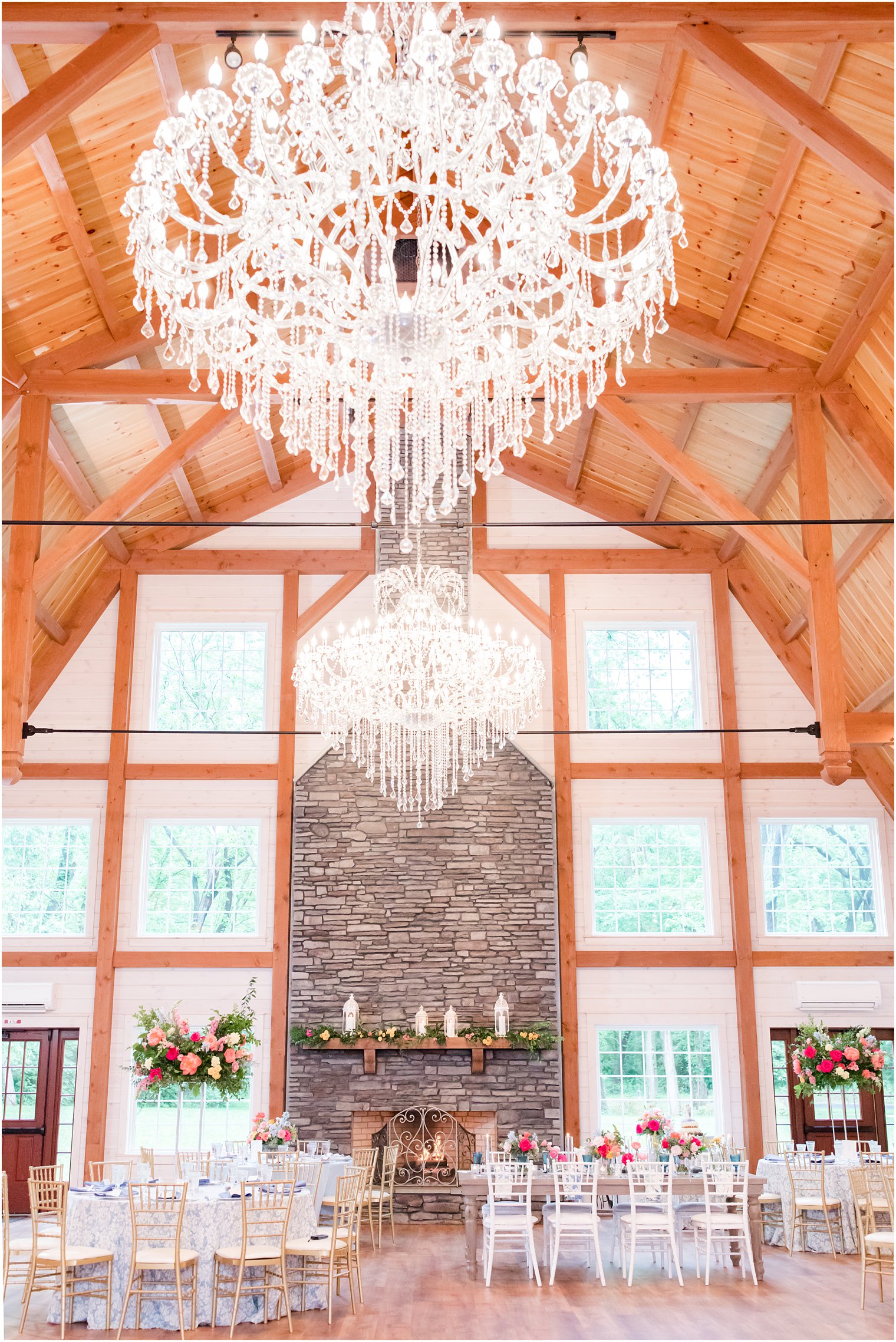 Rosemont Manor wedding reception with stone fireplace and bright colored flowers 