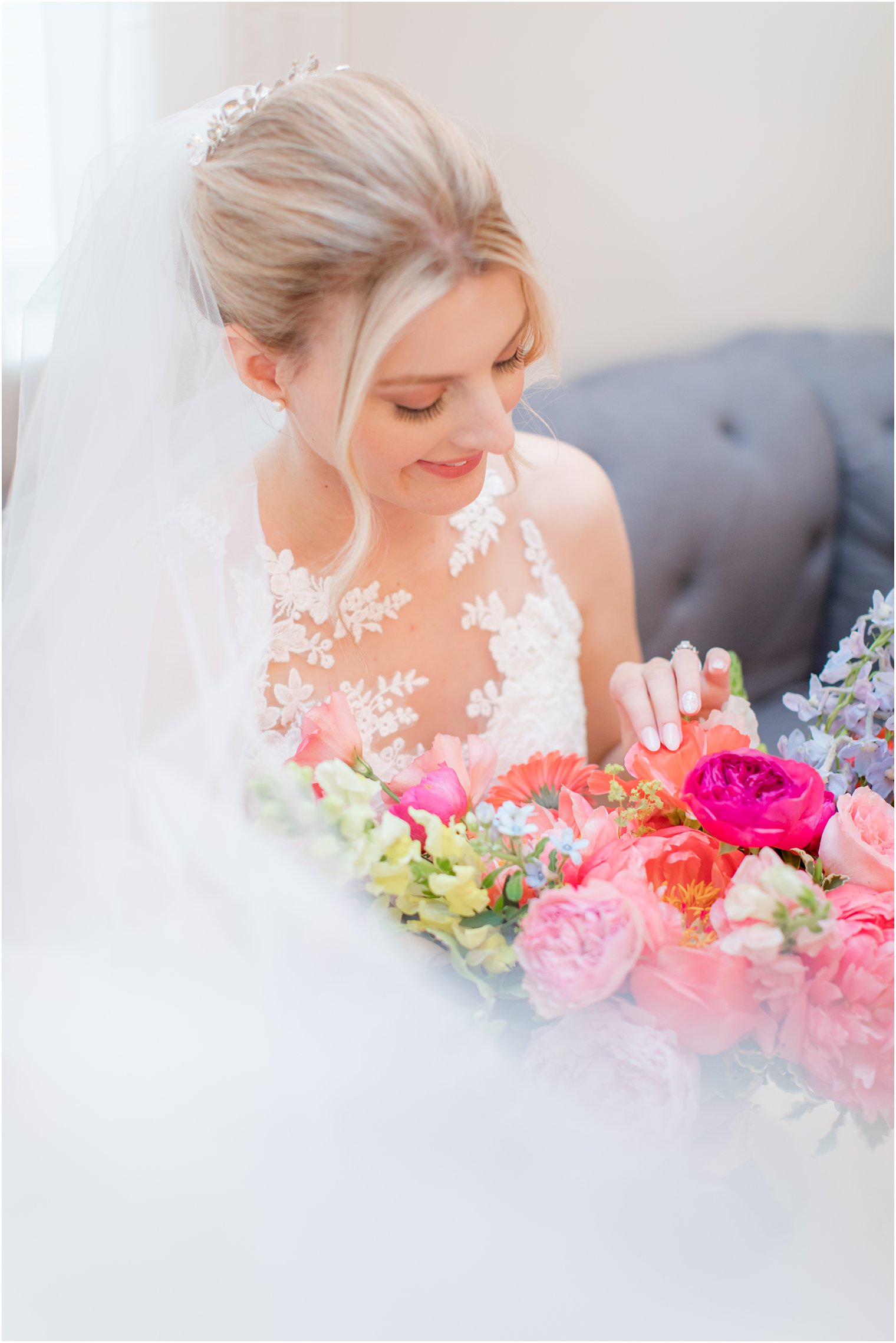 bride looks down at wildflower bouquet before VA wedding