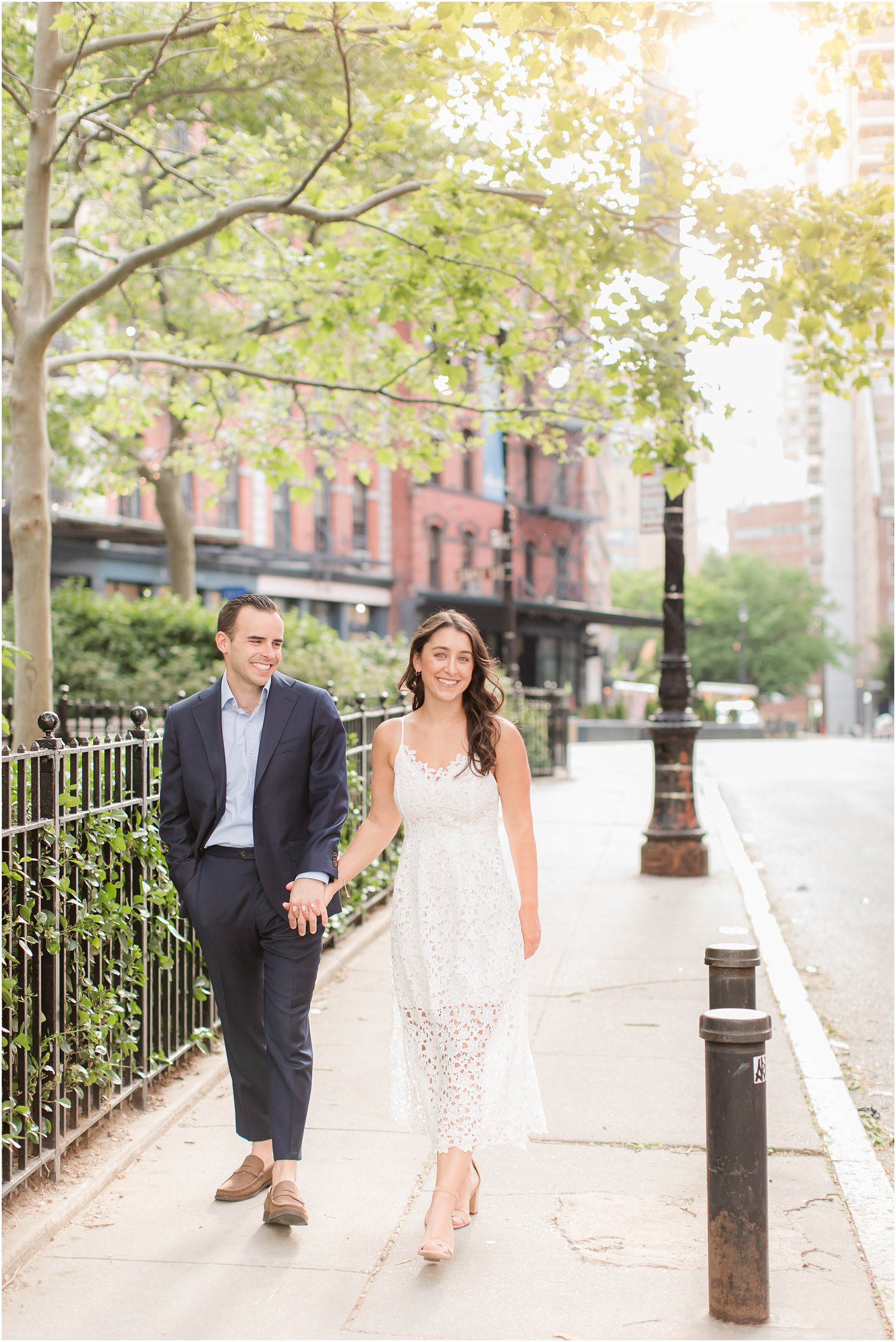 engaged couple walking in Duane Park in Tribeca