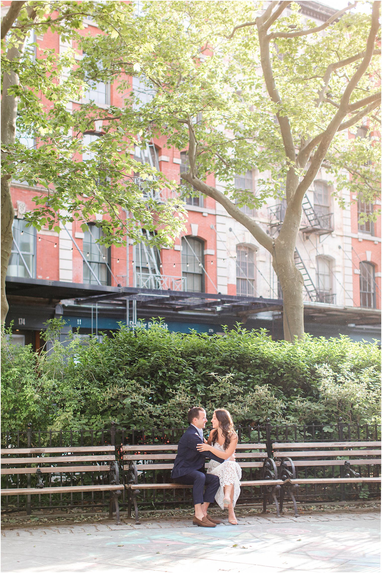 couple sitting on a park bench in Duane Park in Tribeca
