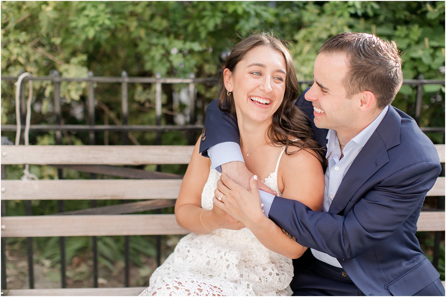 candid engagement photo taken on a park bench in Duane Park