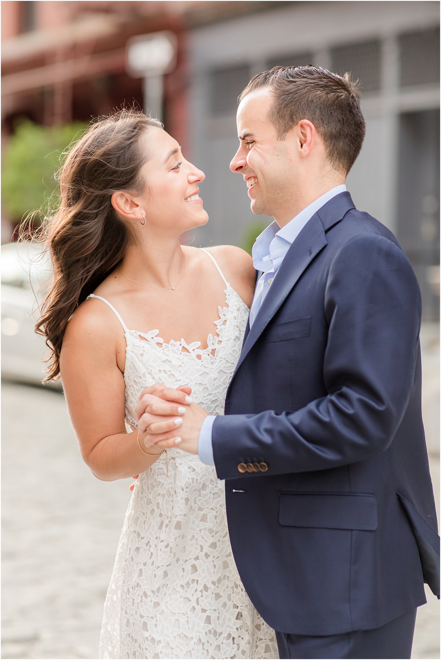 engaged couple dancing in Tribeca on a cobblestone street