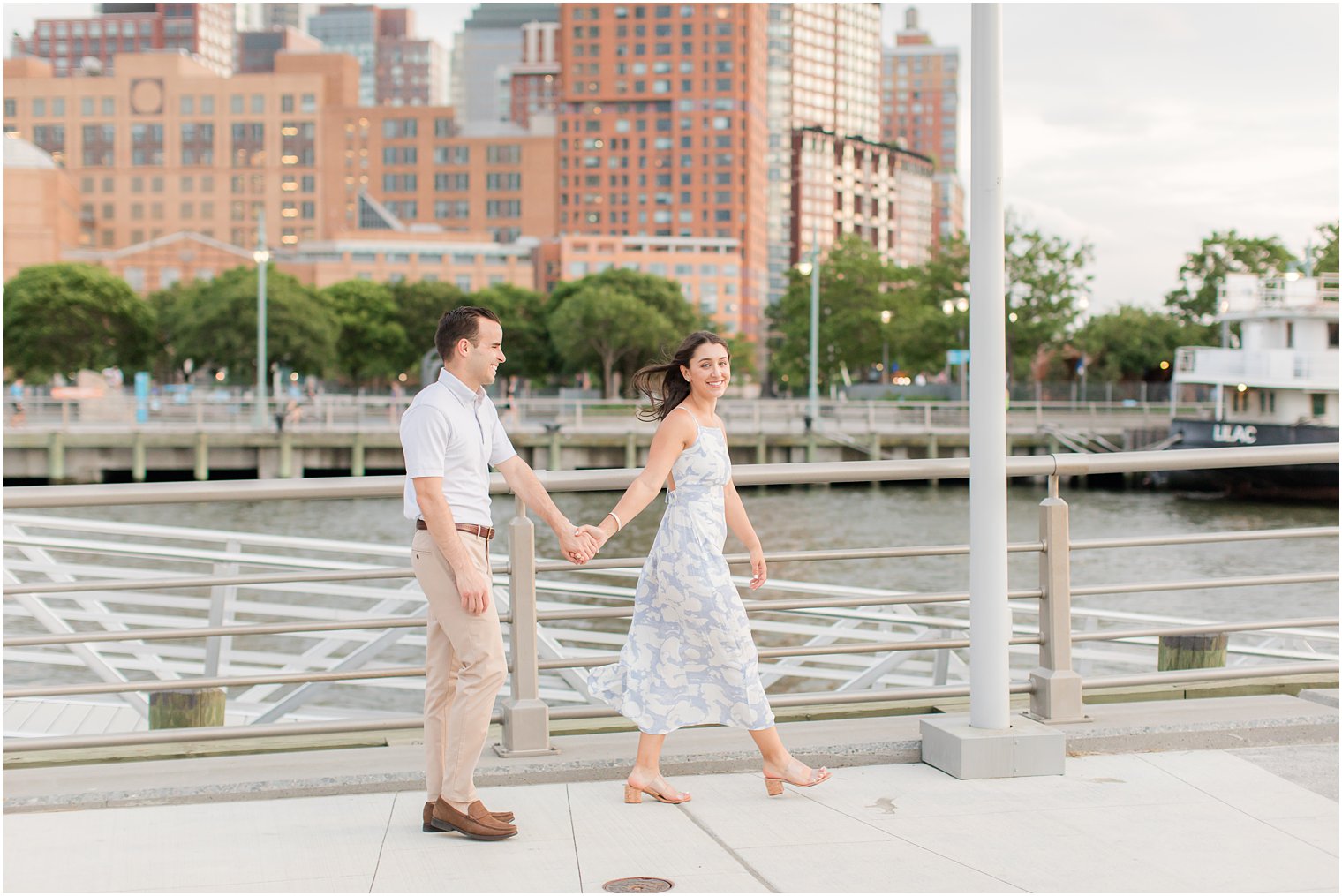 engaged couple walking on Pier 26