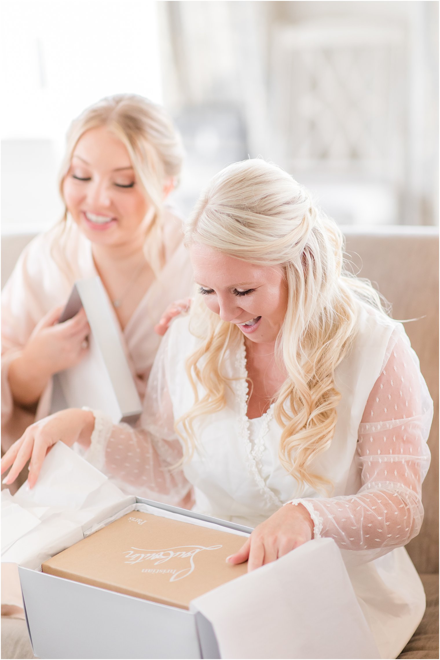 bride opening gift on wedding morning with bridesmaids 